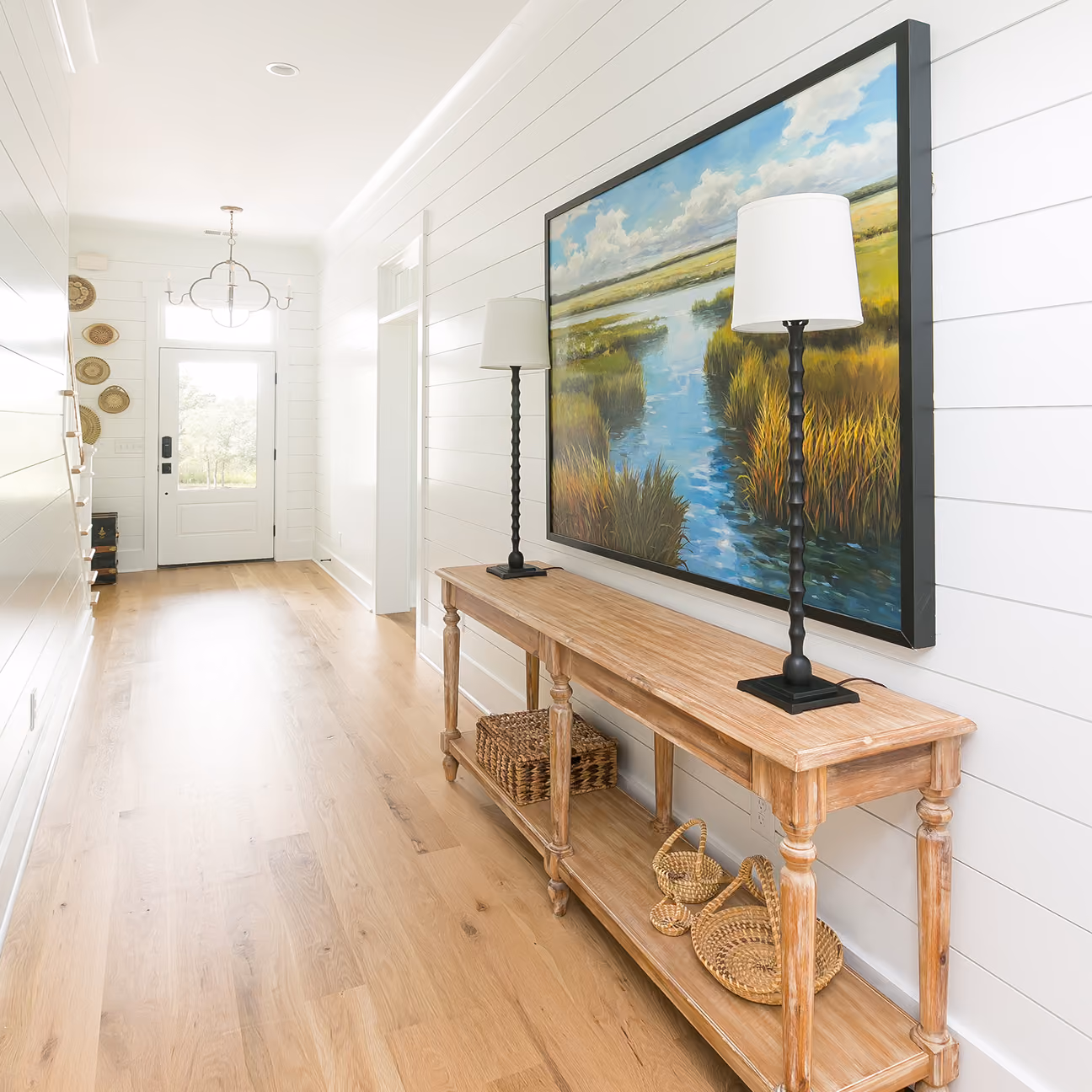 Residential entryway with a console table and hardwood flooring