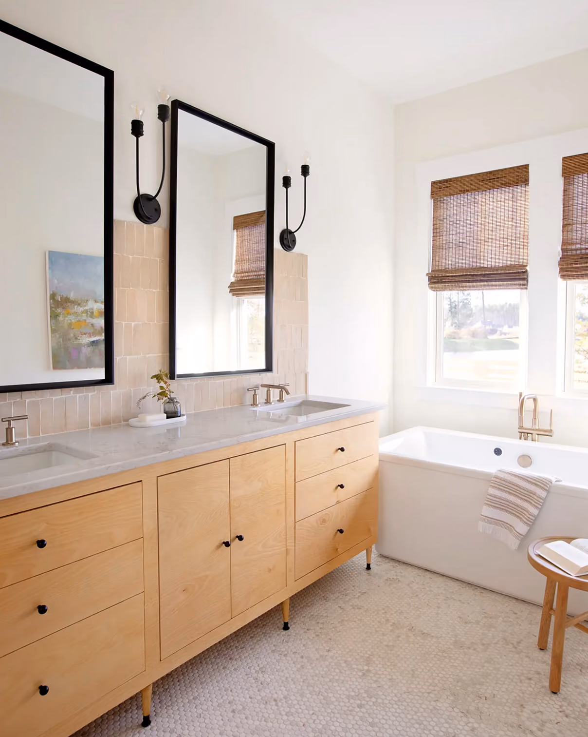 Residential bathroom with a wood vanity, soaking tub, and tile flooring