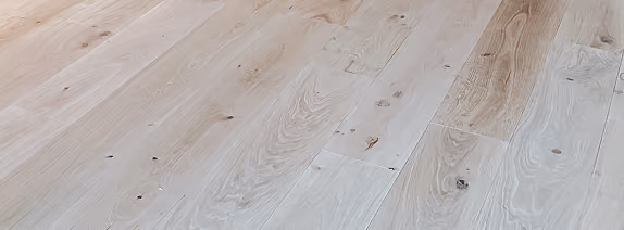 Close-up of light gray commercial flooring with linear seams