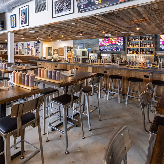 Restaurant dining area with wood chairs and a patterned mosaic tile floor