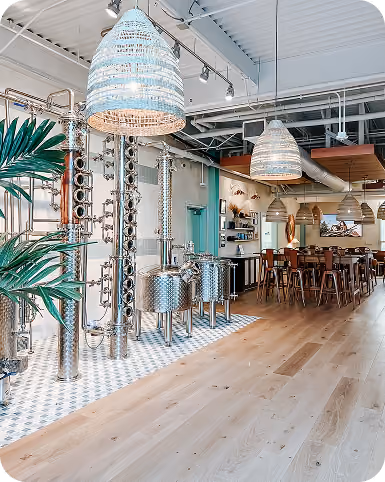 Restaurant distillery bar area with copper still equipment and patterned tile flooring
