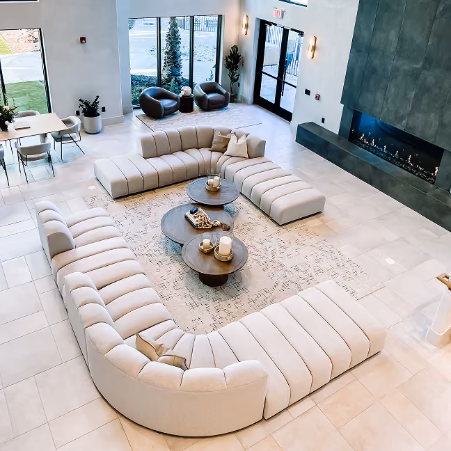 Apartment living room with a sectional sofa and white flooring