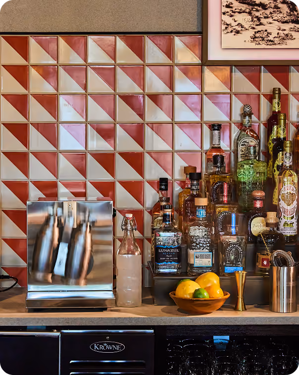Restaurant bar with a red and white patterned tile accent wall