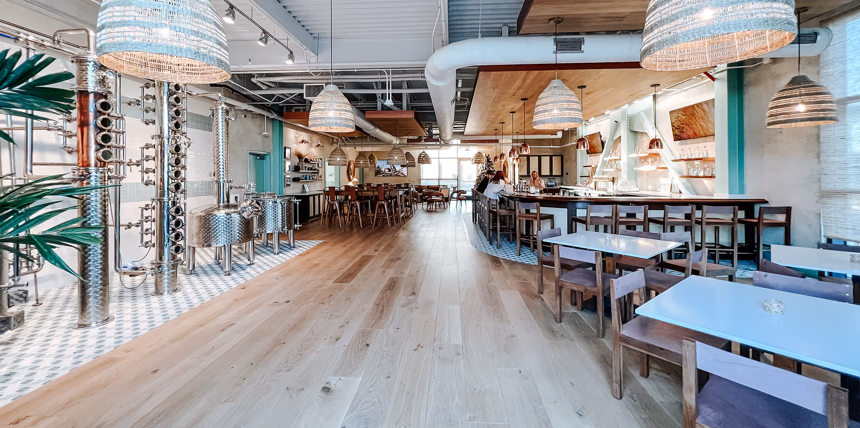 Restaurant dining area with teal walls, hardwood flooring, and a service counter