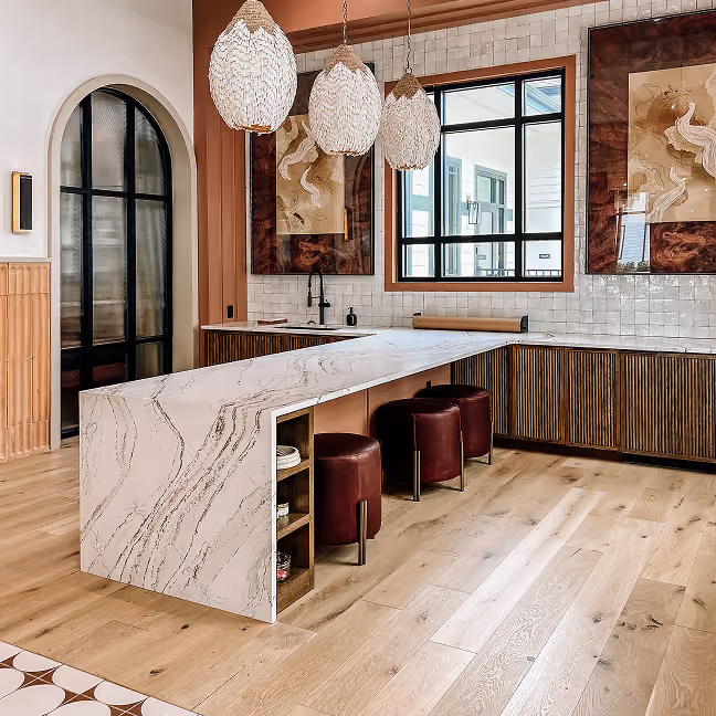 Apartment kitchen island with a wood beam ceiling and dark hardwood flooring