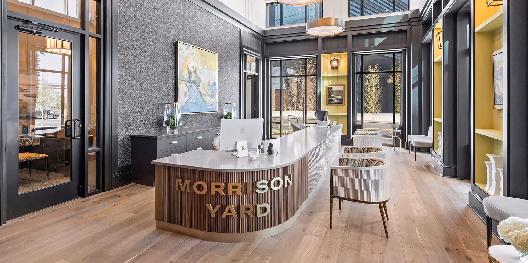 Multi-family building lobby with pendant lighting and light tile flooring