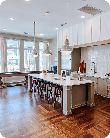 Apartment kitchen with a marble-look island and light tile flooring