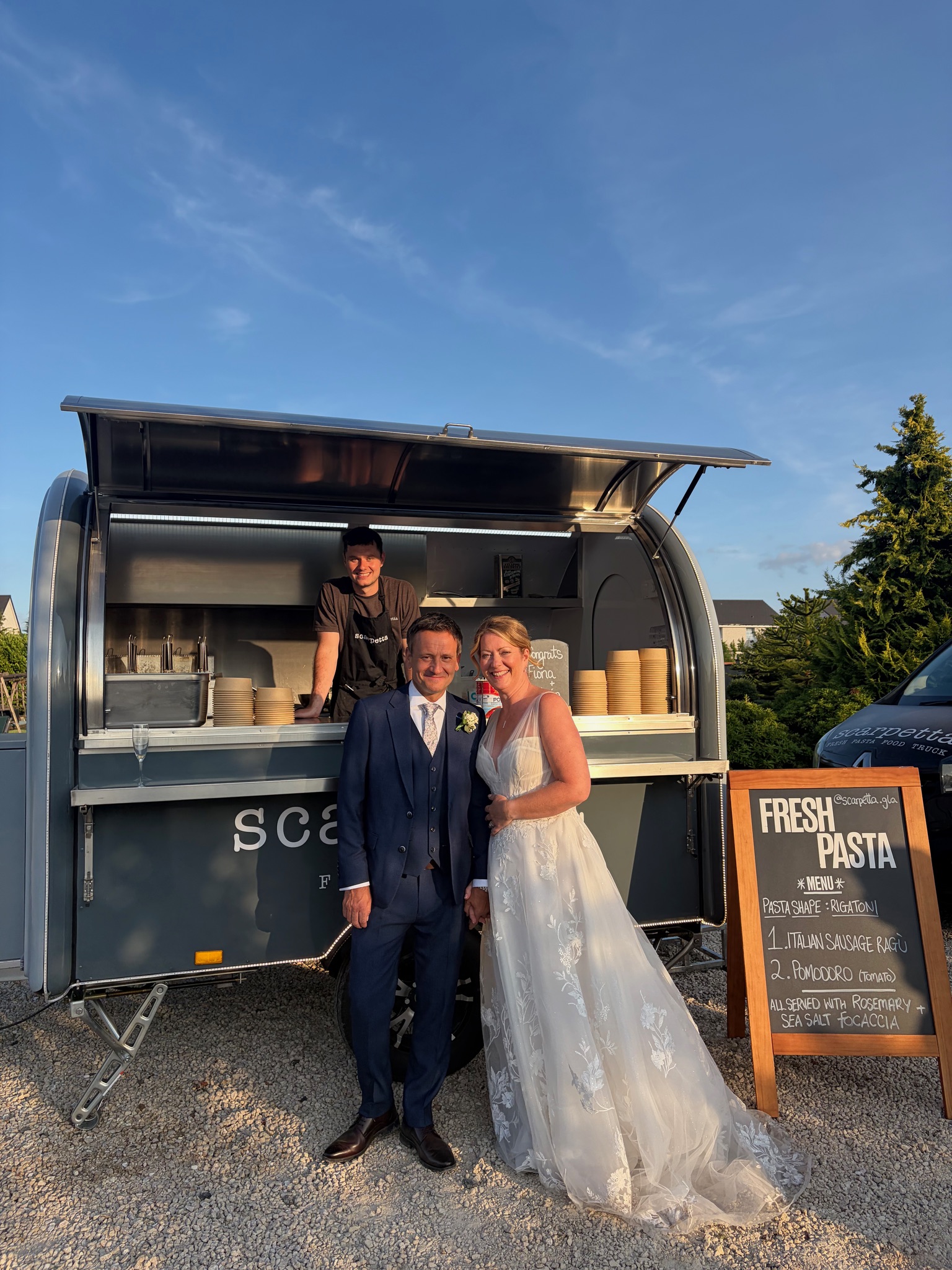 Wedding guests at golden hour with the truck