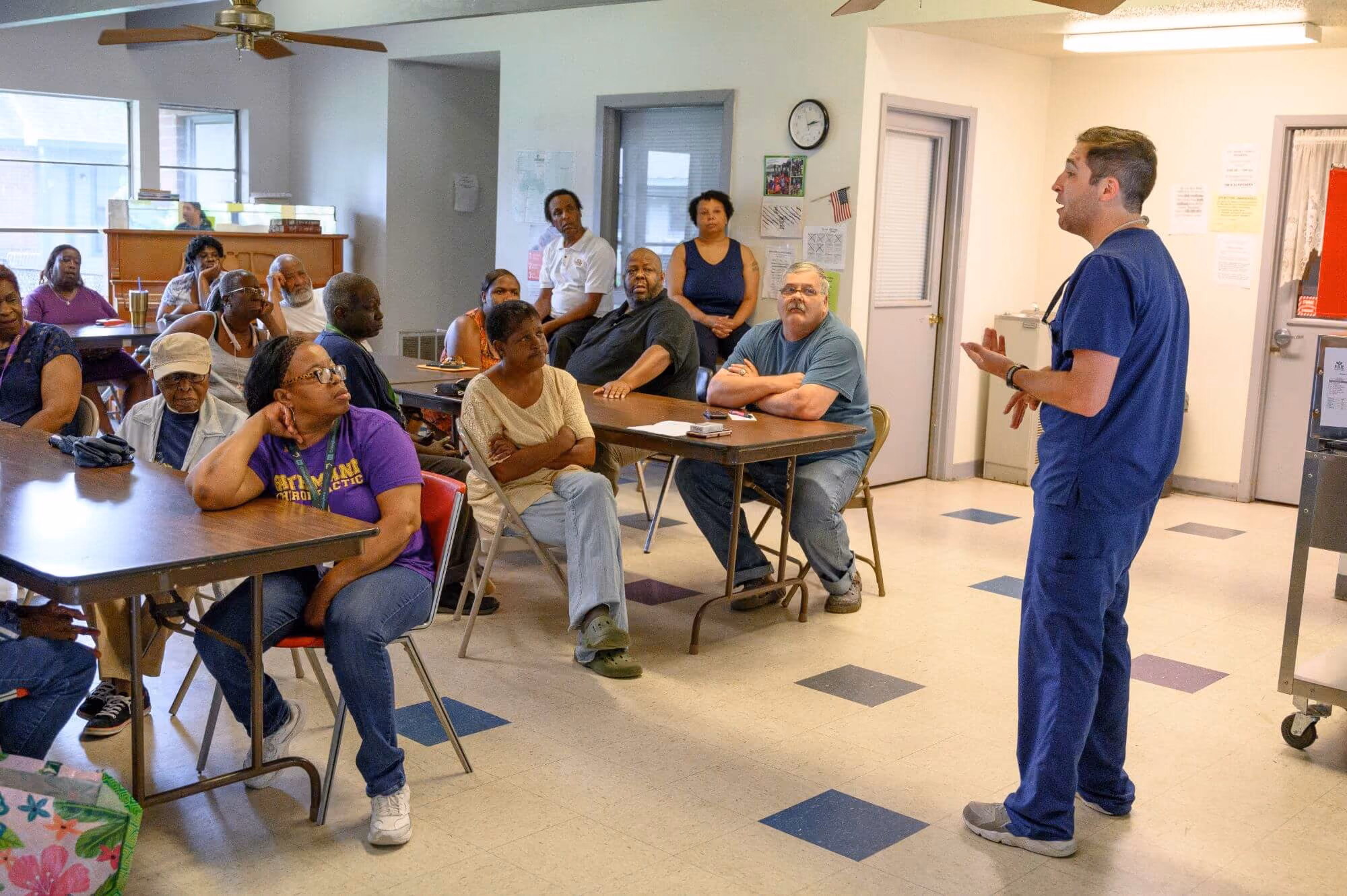 Residents raising their hands during a community meeting