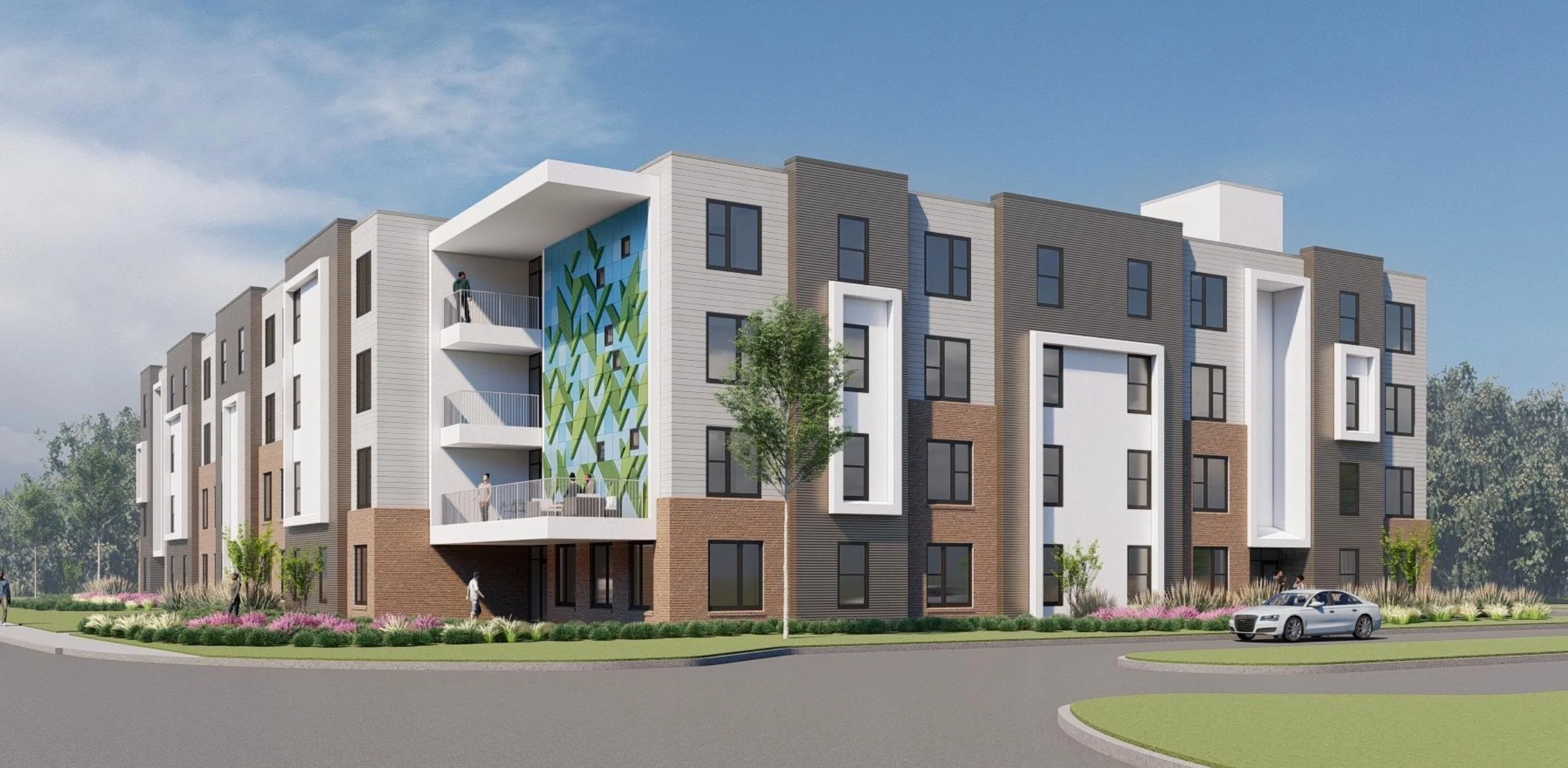 Modern four-story apartment building with a mix of brick and light siding exterior, featuring balconies with people, large windows, and a colorful geometric mural on one side, surrounded by landscaped greenery and a parked silver car on a curved road.