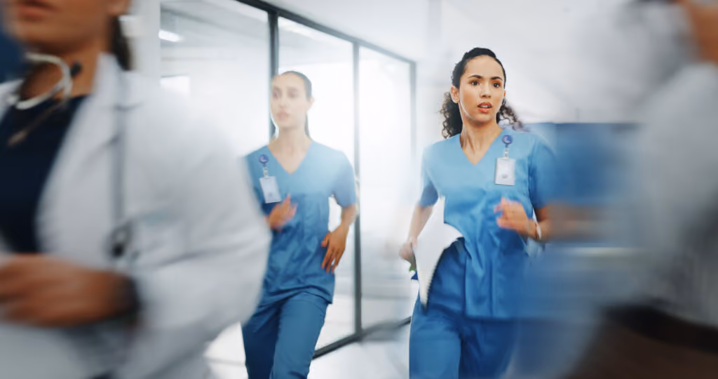 Nurses wearing CrisisAlert badges running to assist in an emergency