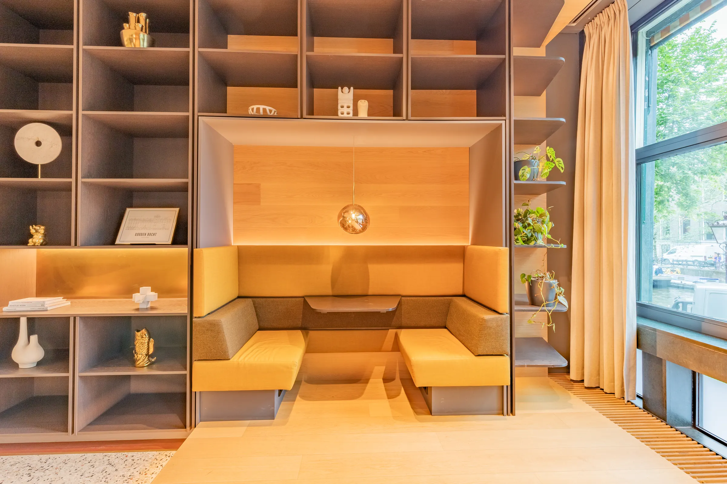 Built-in library nook with a canal-side window