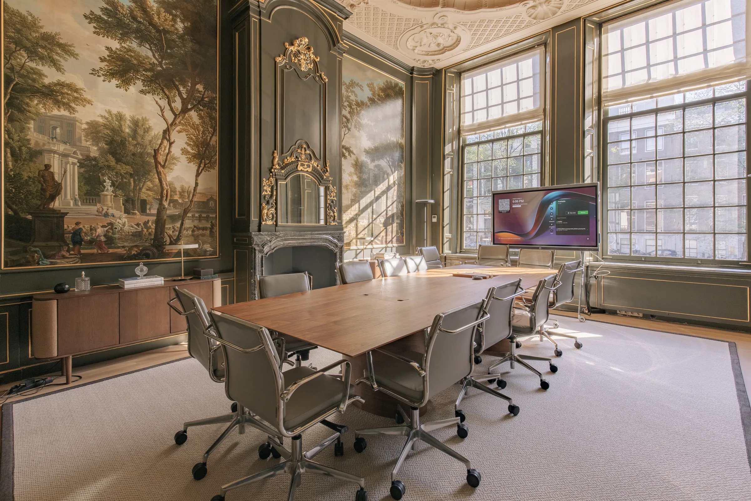 Boardroom with 18th-century painted wall panels, a marble fireplace and a conference table