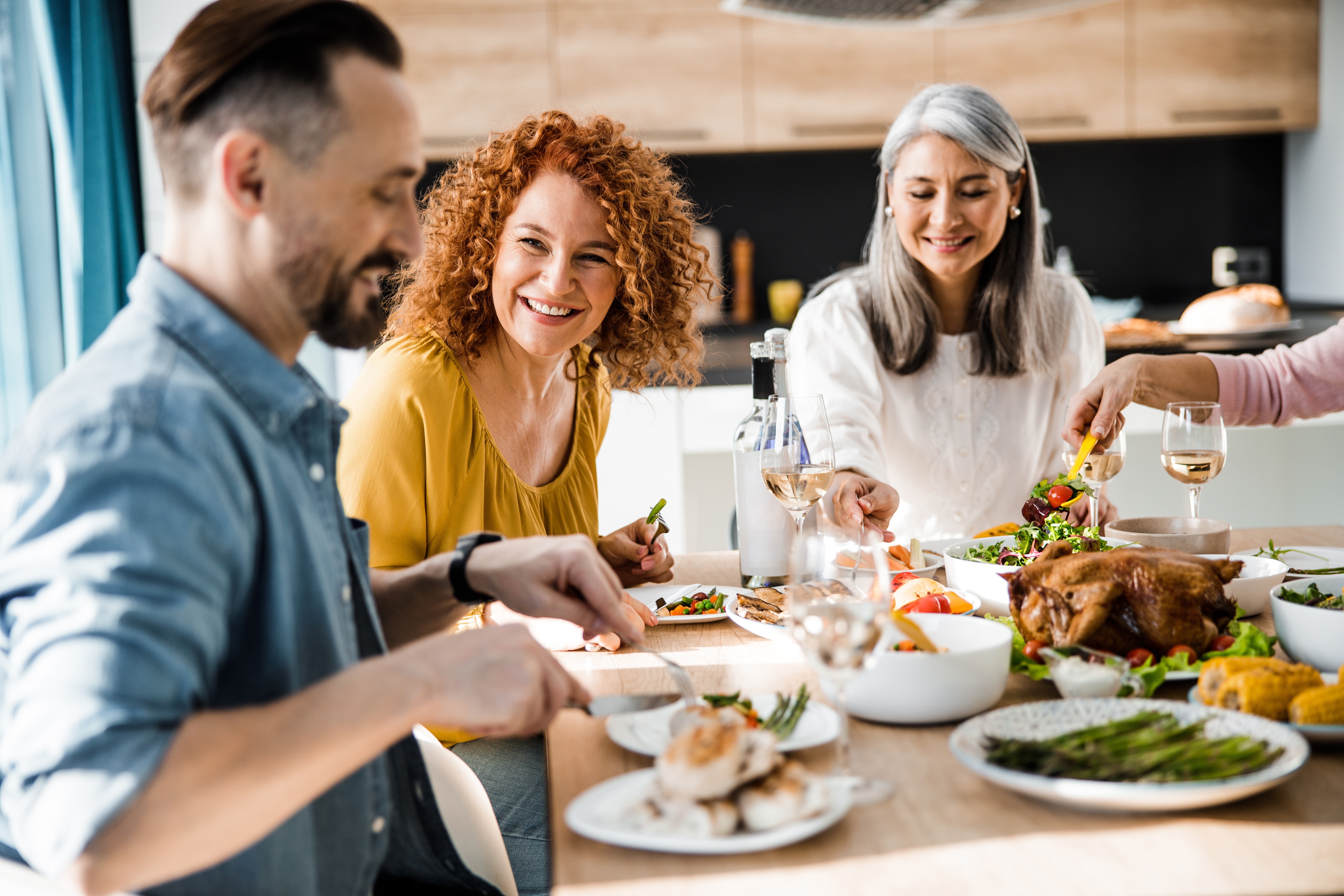 People at table eating and passing food stock image
