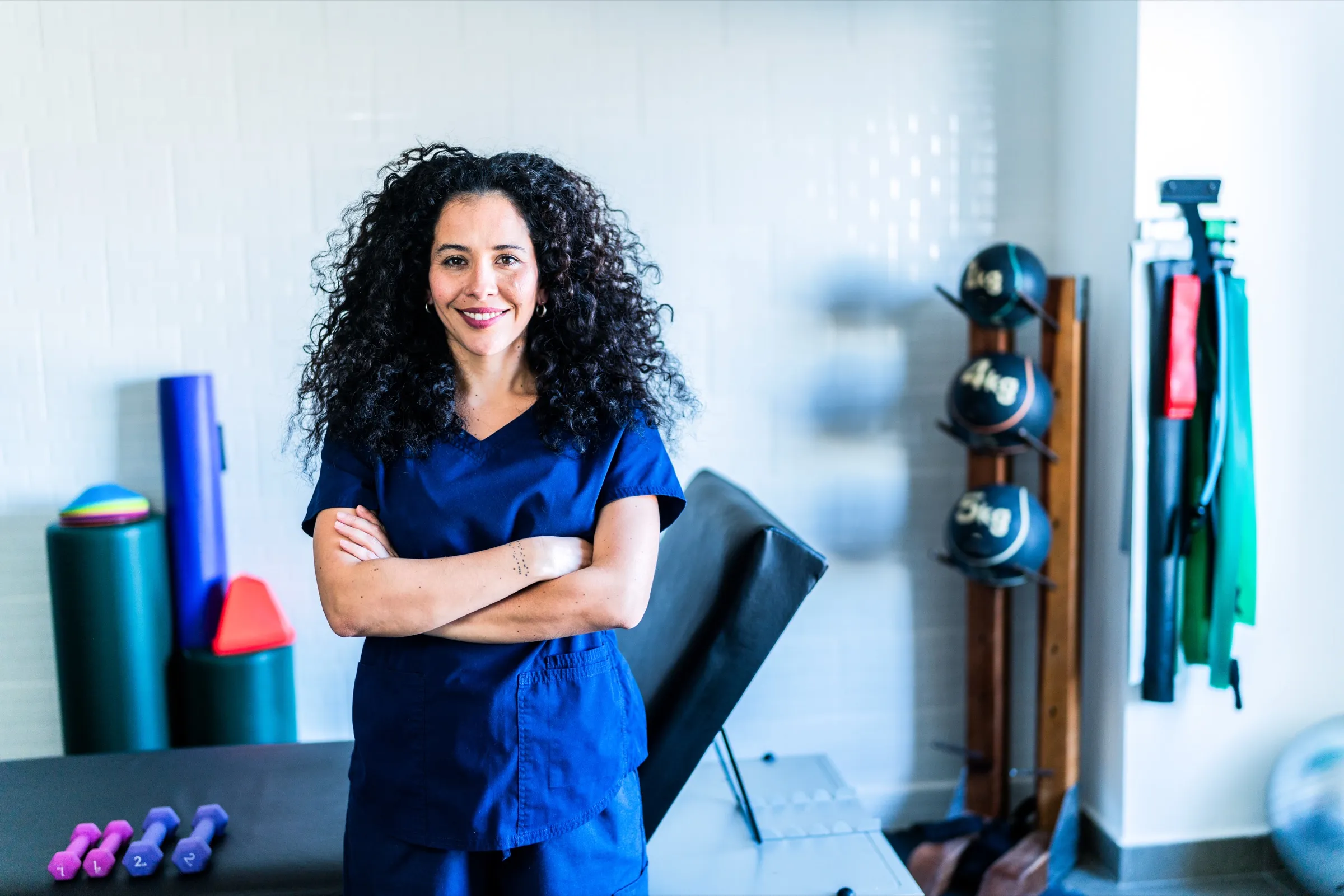 Physical therapist standing in a rehabilitation gym