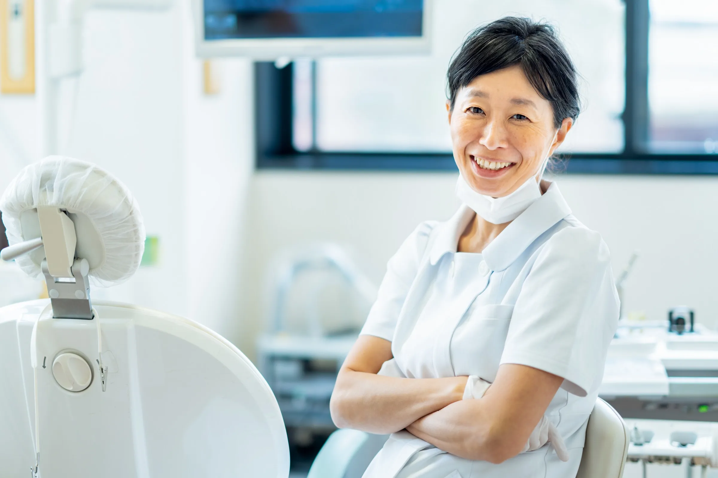 Dentist standing beside dental imaging equipment