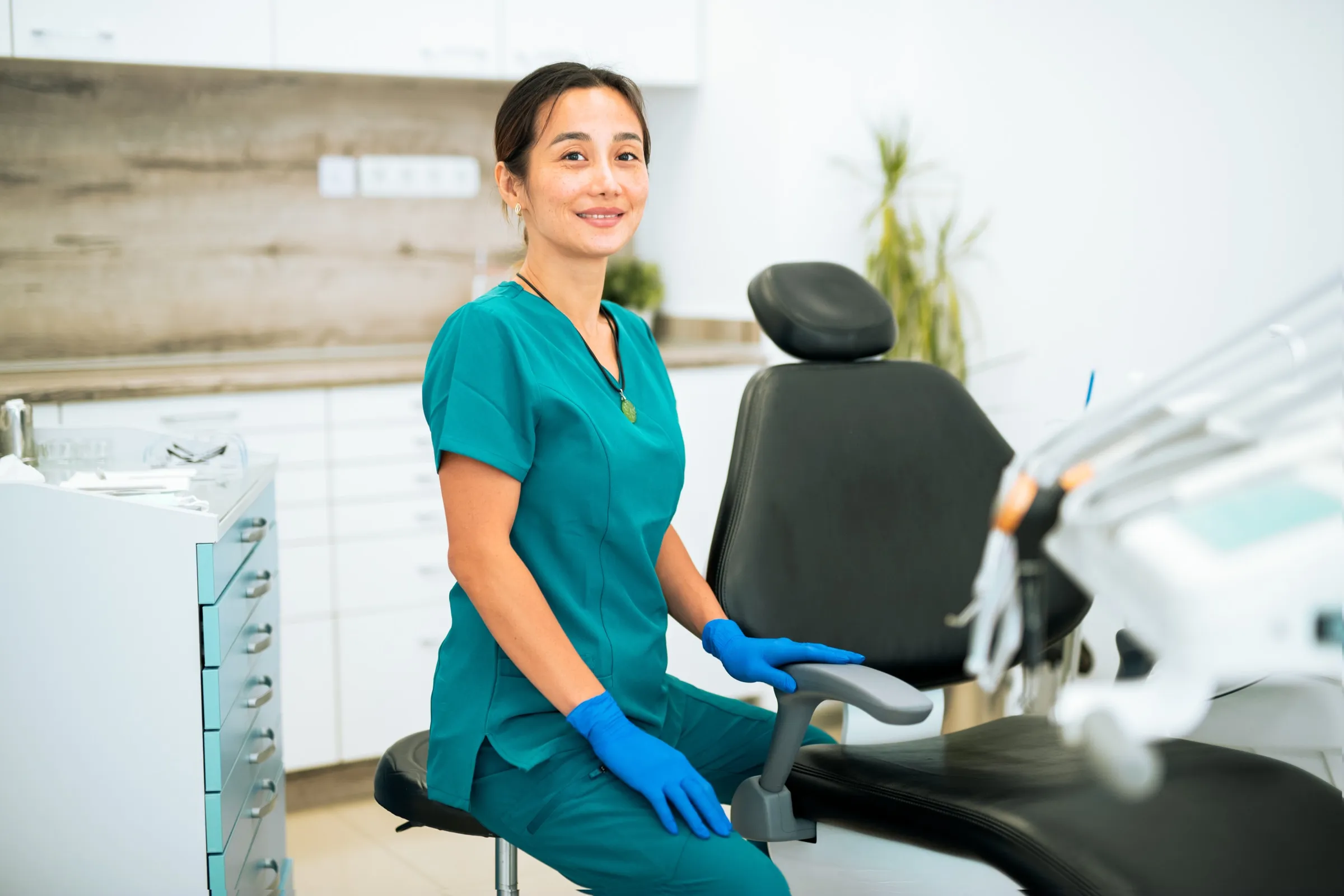 Dental assistant beside a dental chair