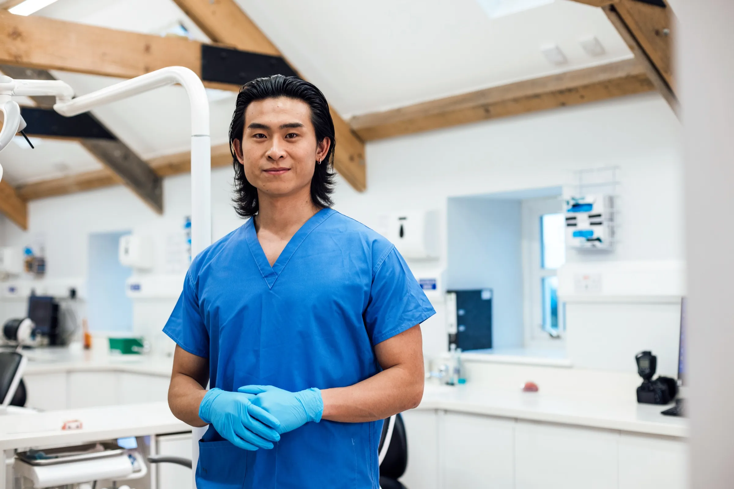 Dentist in scrubs in a dental treatment room