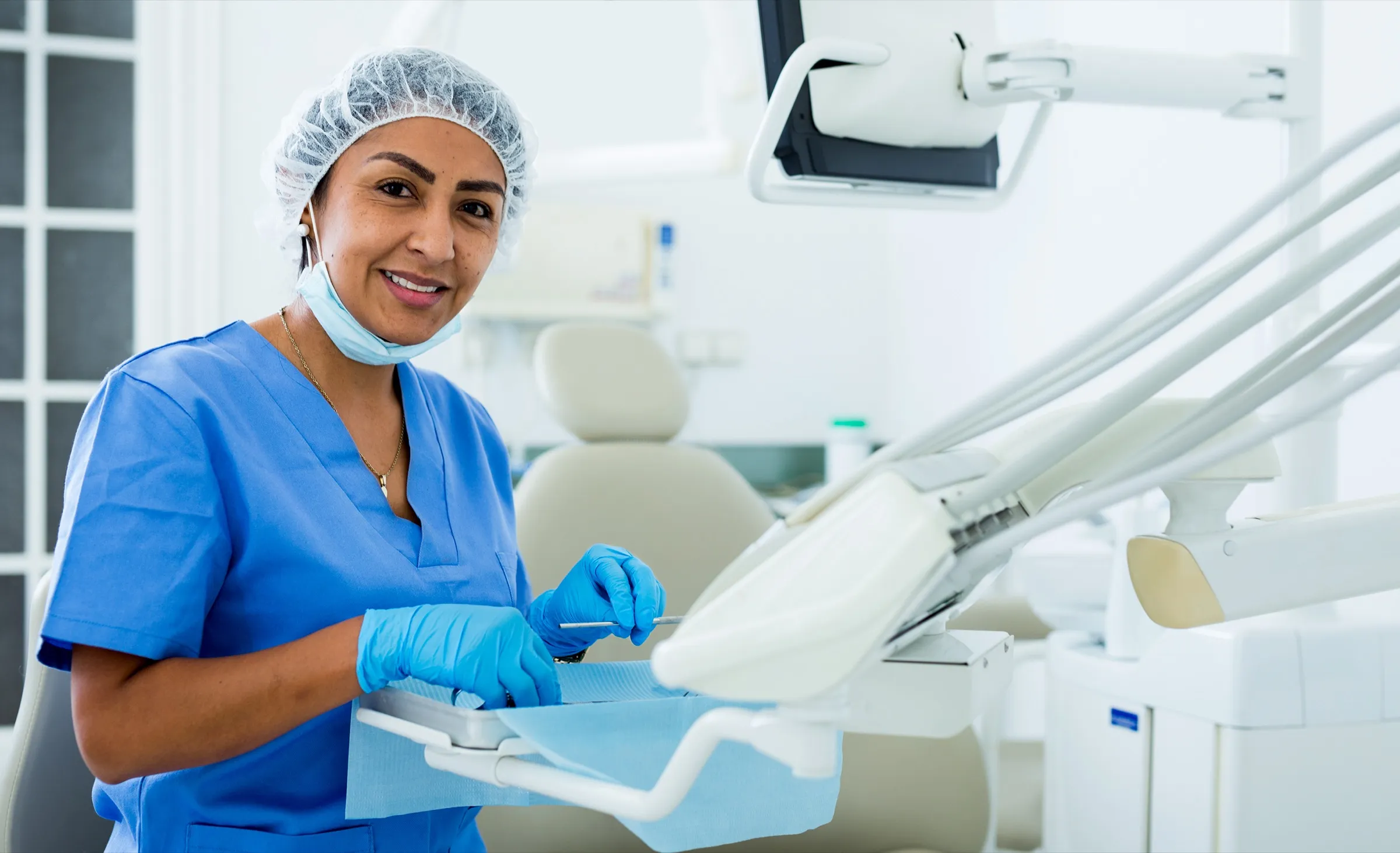 Dental assistant preparing a treatment room