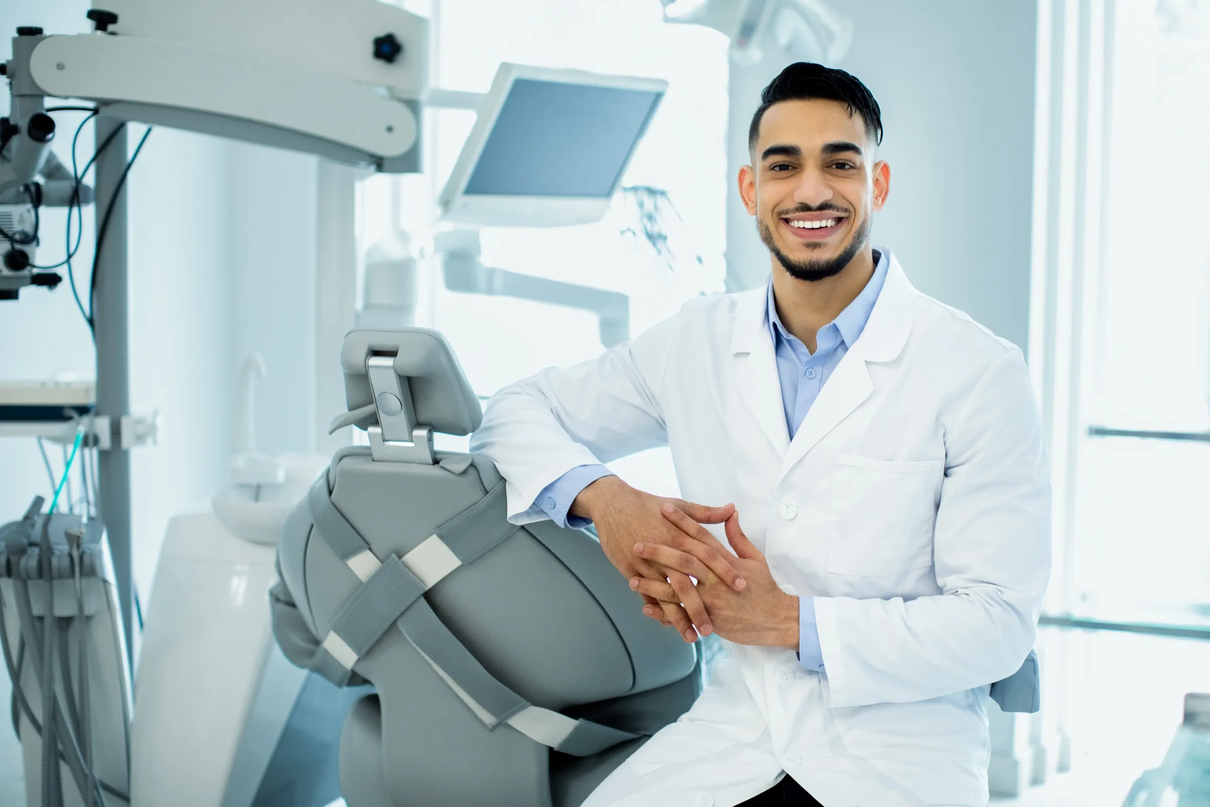Dentist beside a dental chair