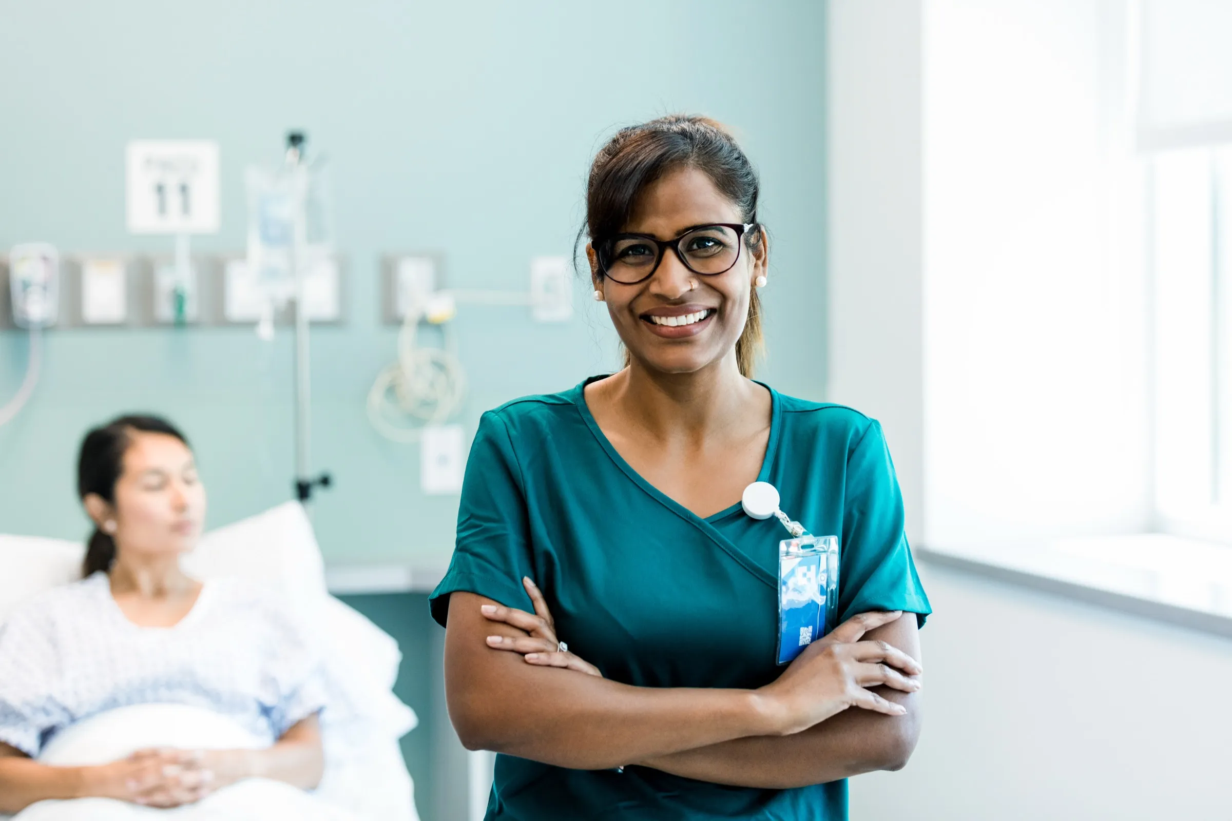 Nurse at a patient bedside in a hospital room