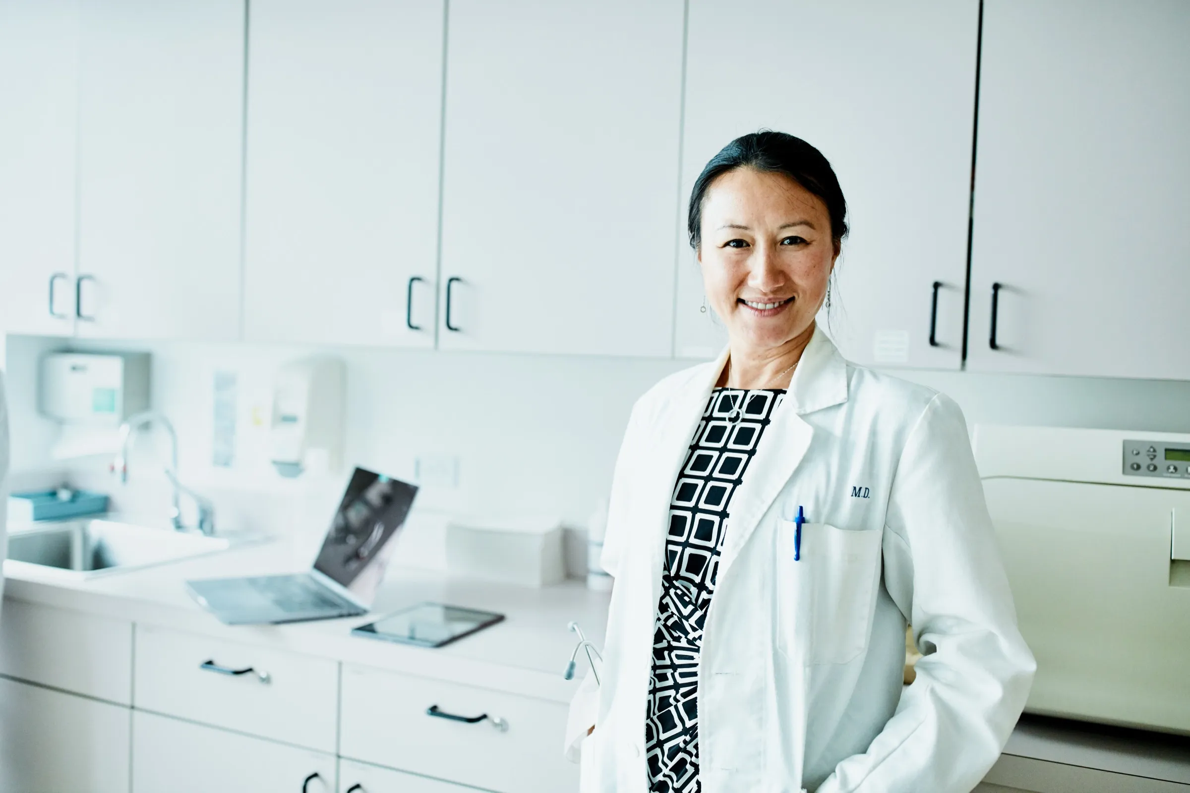 Physician standing in a clinic exam room