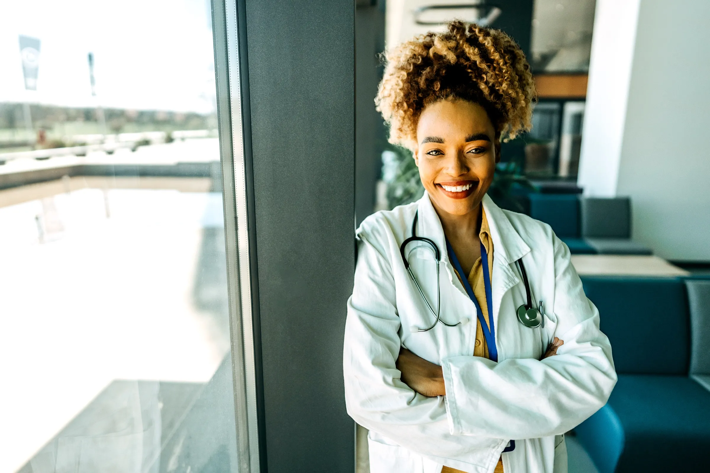 Physician standing by a hospital window