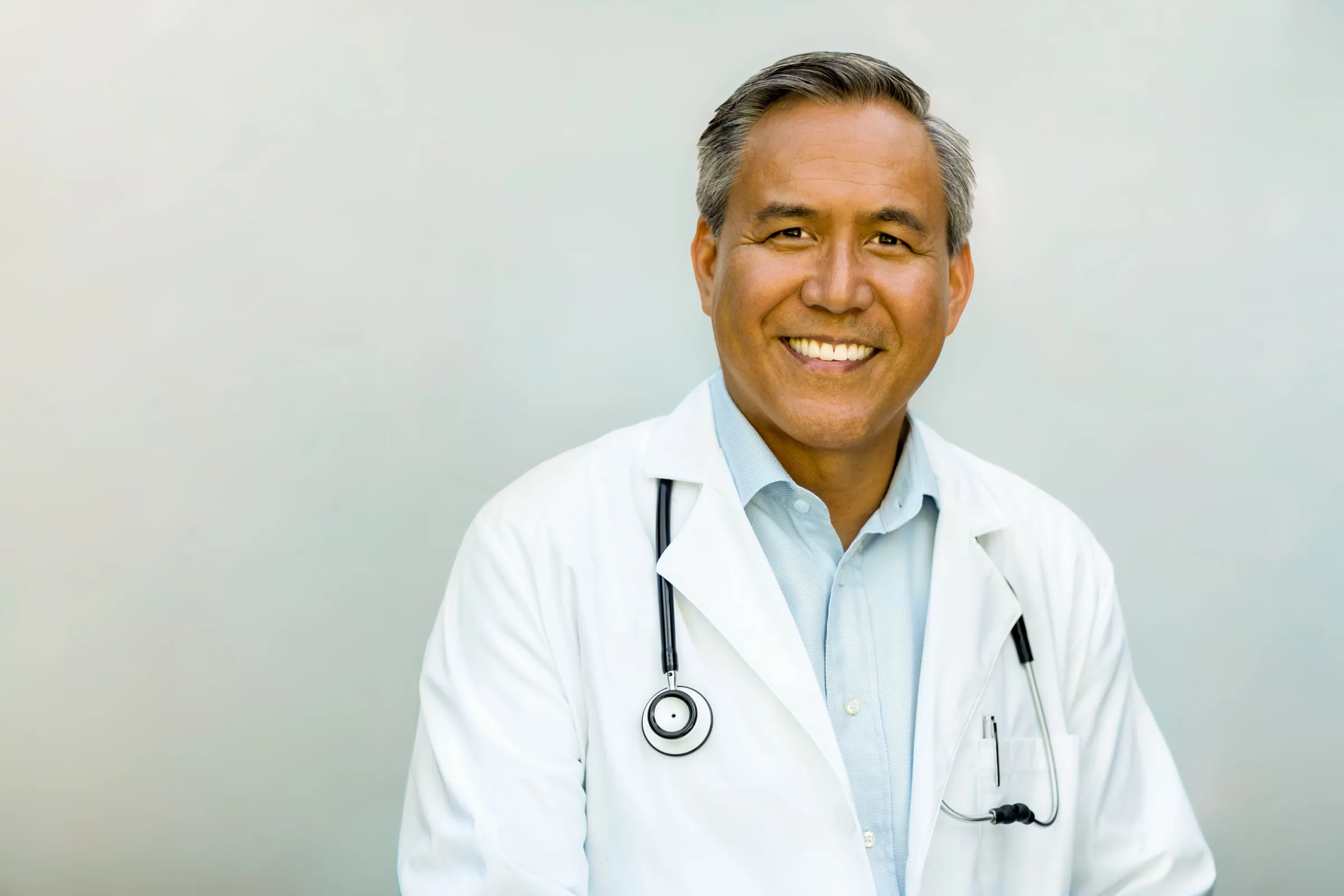 Physician wearing a white coat and stethoscope