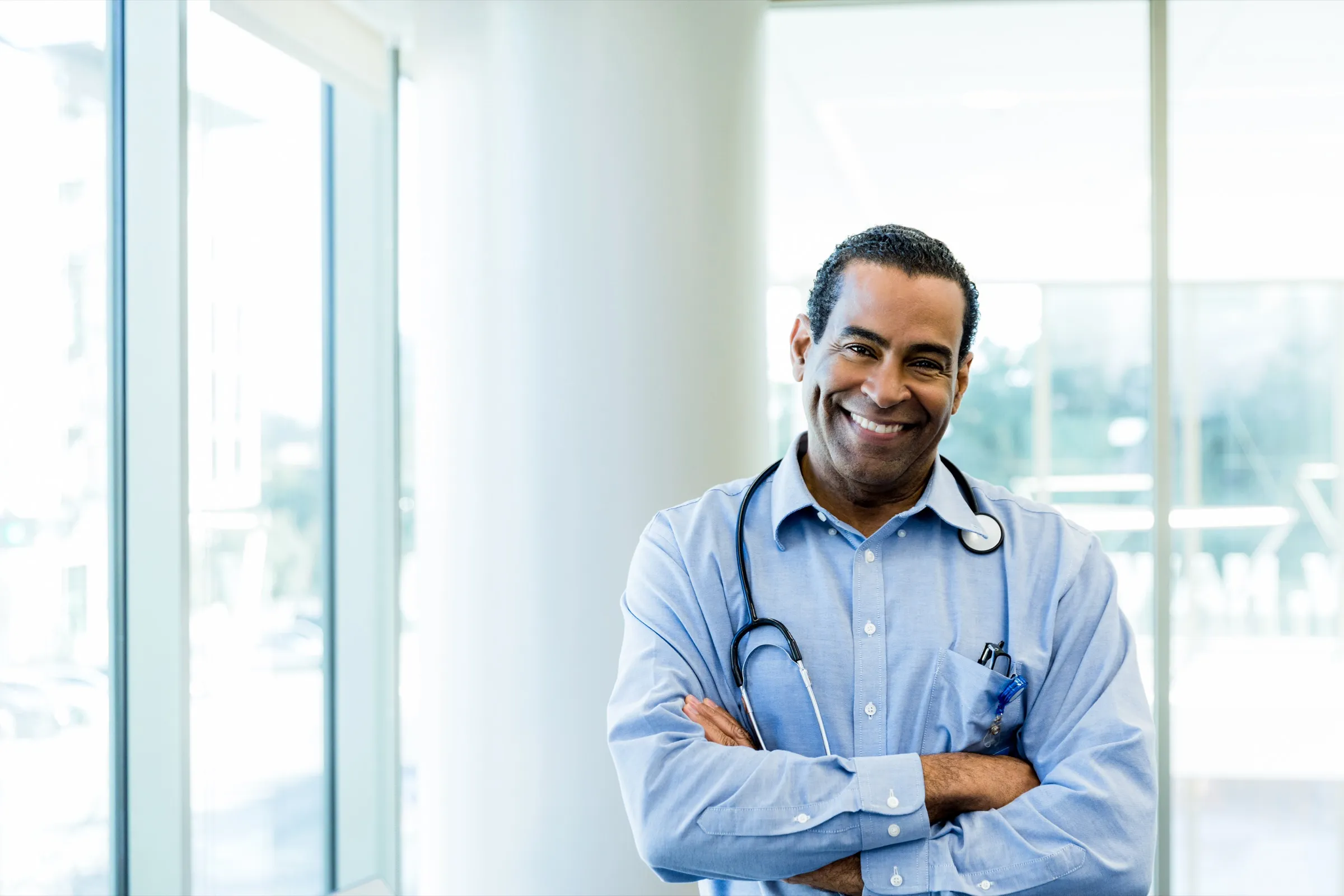 Physician standing by a window in a clinic