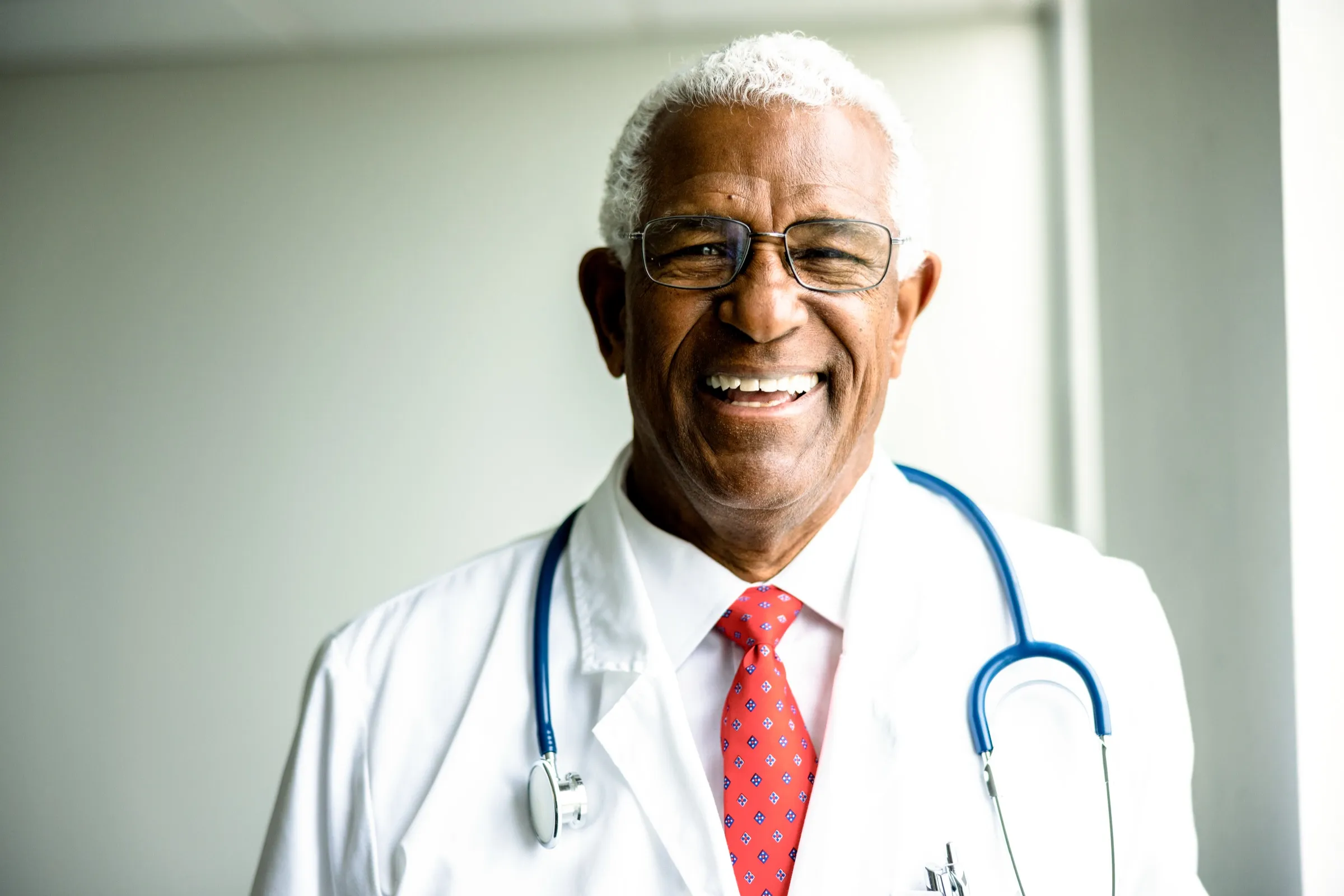 Physician wearing a white coat and tie