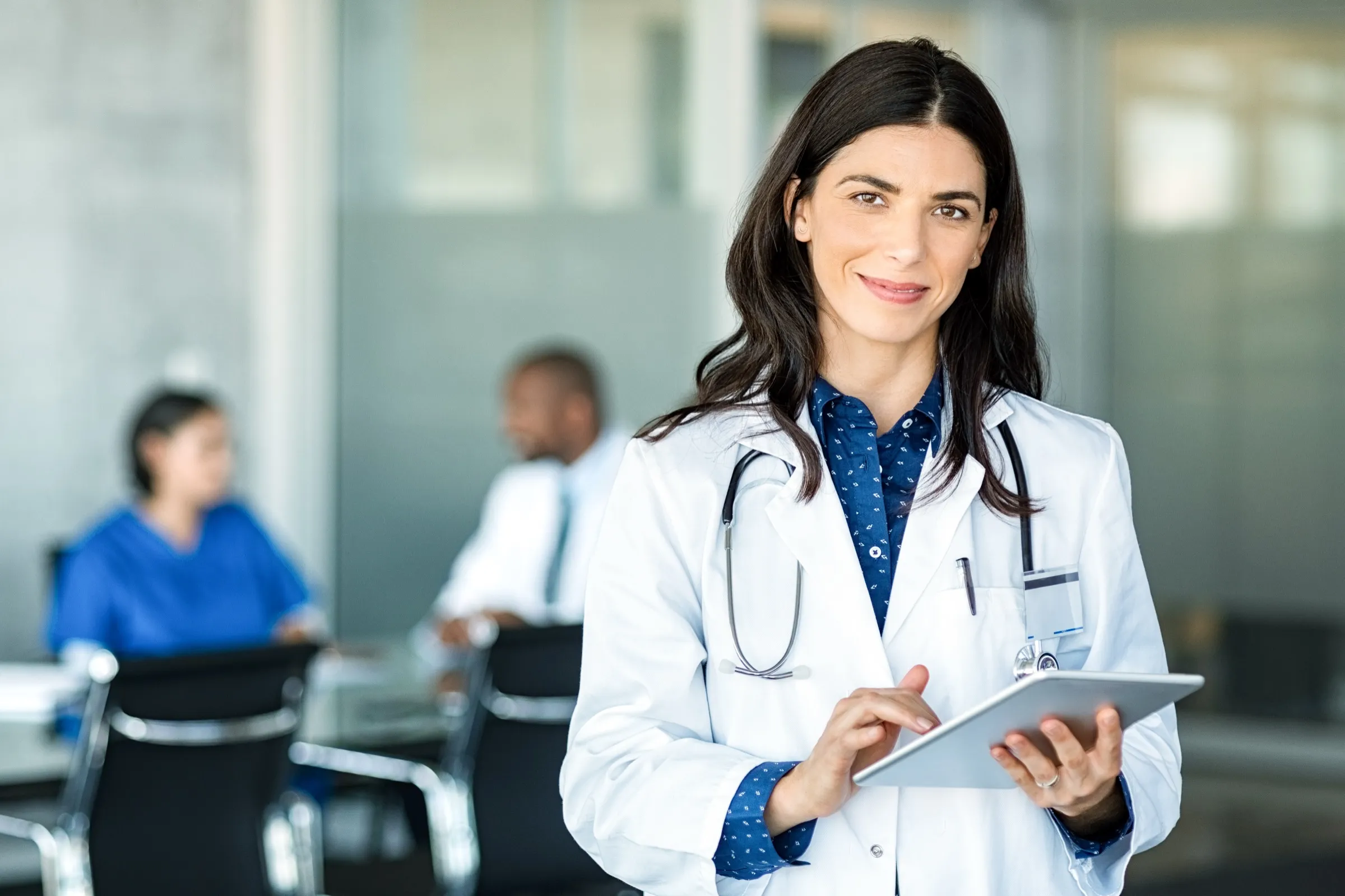 Physician with a tablet in a hospital meeting room