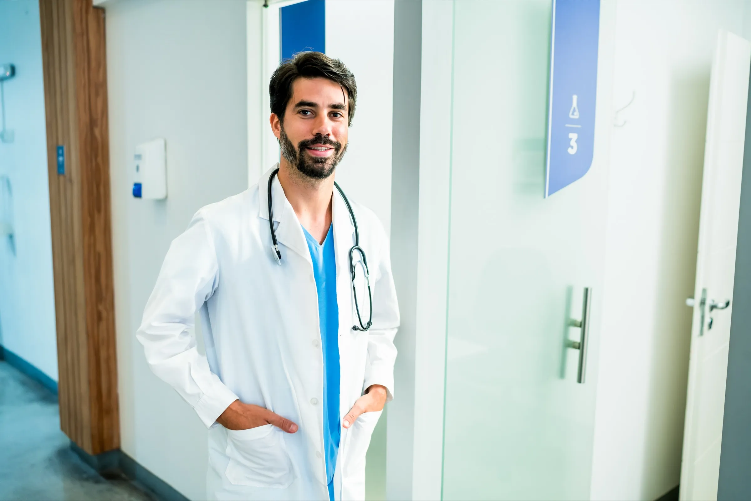 Physician standing at the door of an exam room