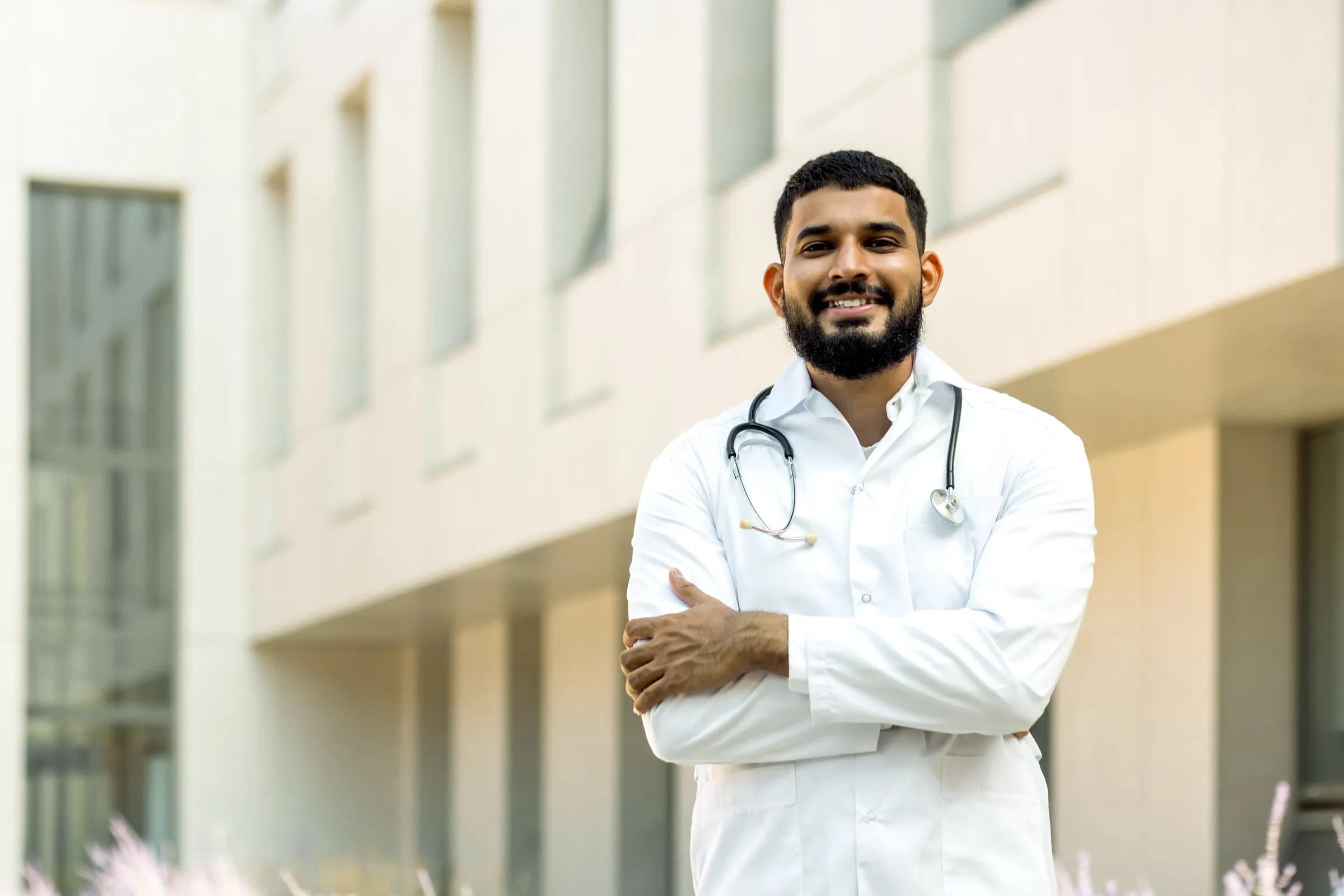 Physician standing outside a hospital building