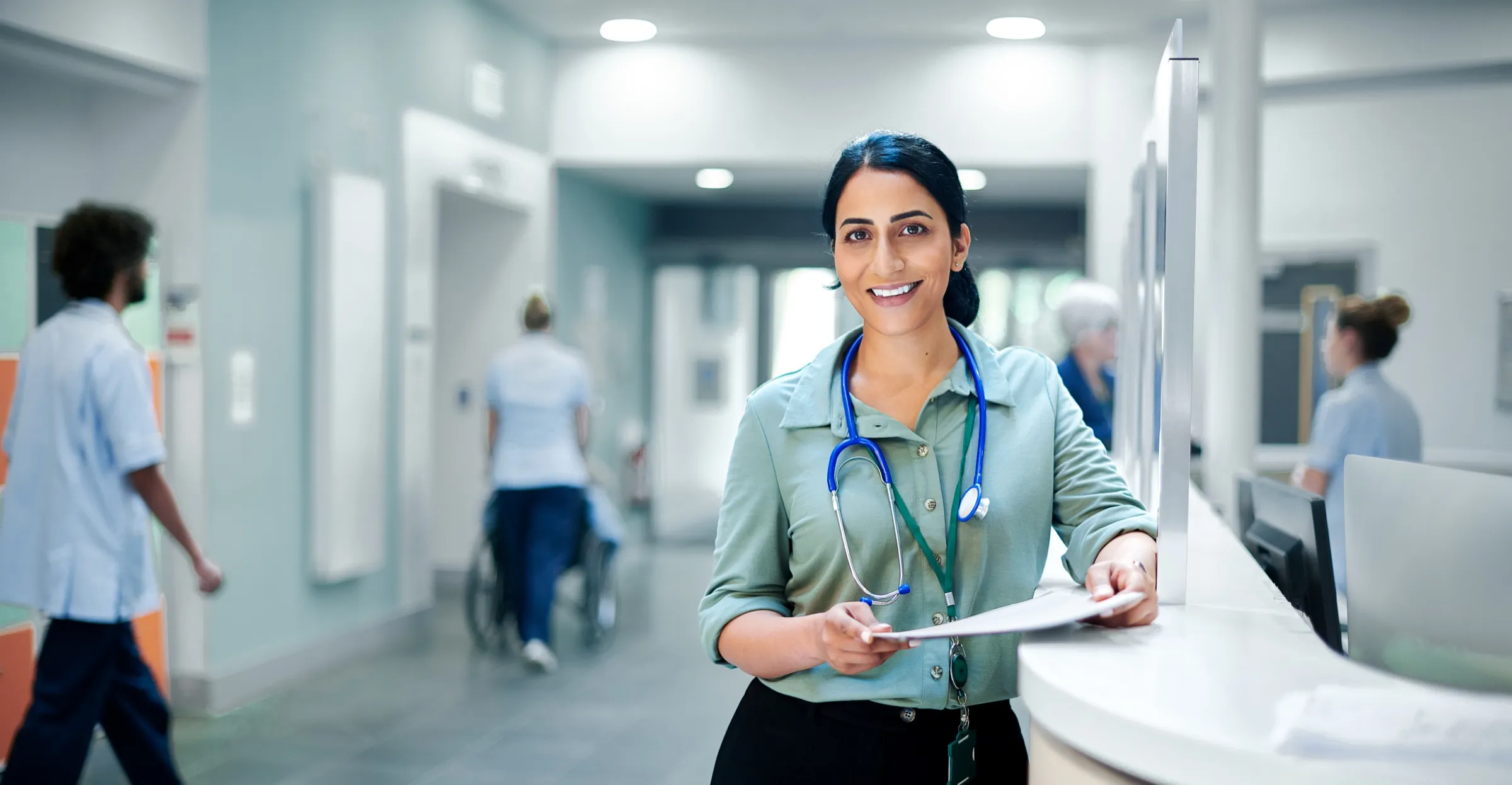 Physician reviewing notes on a hospital ward
