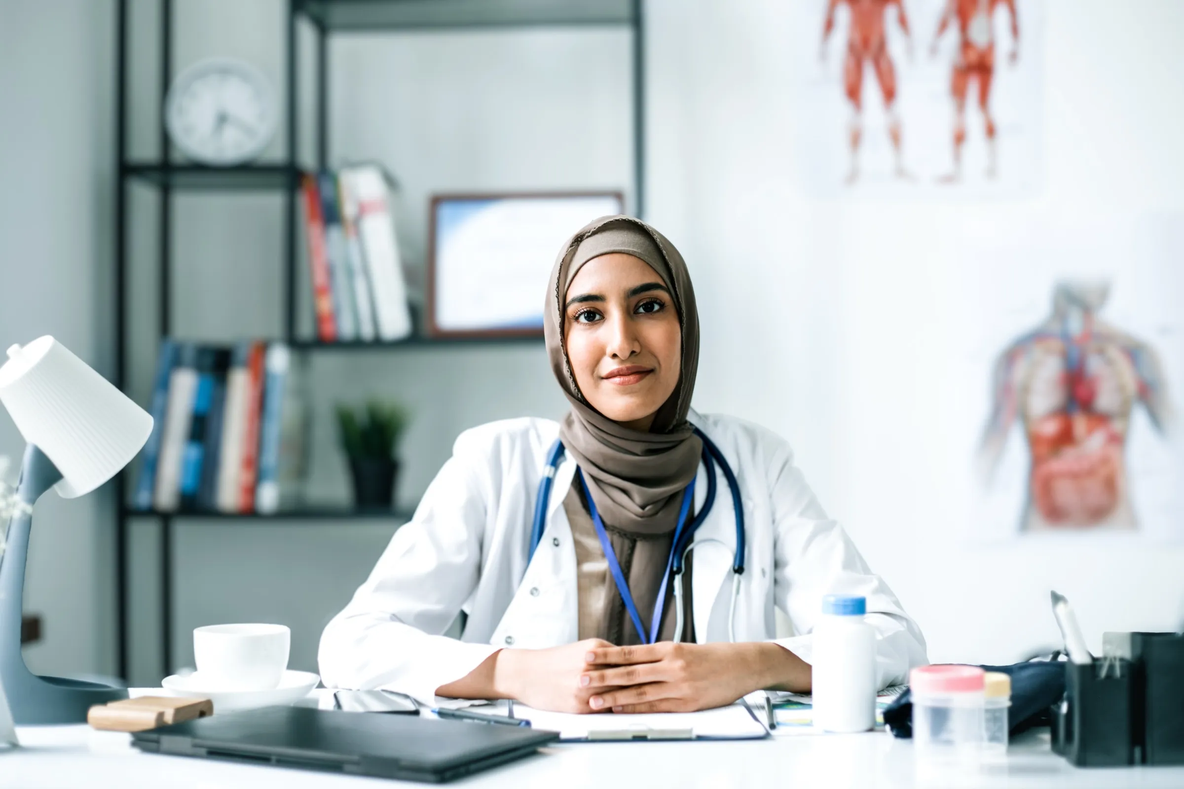 Physician seated at a desk in a consultation room