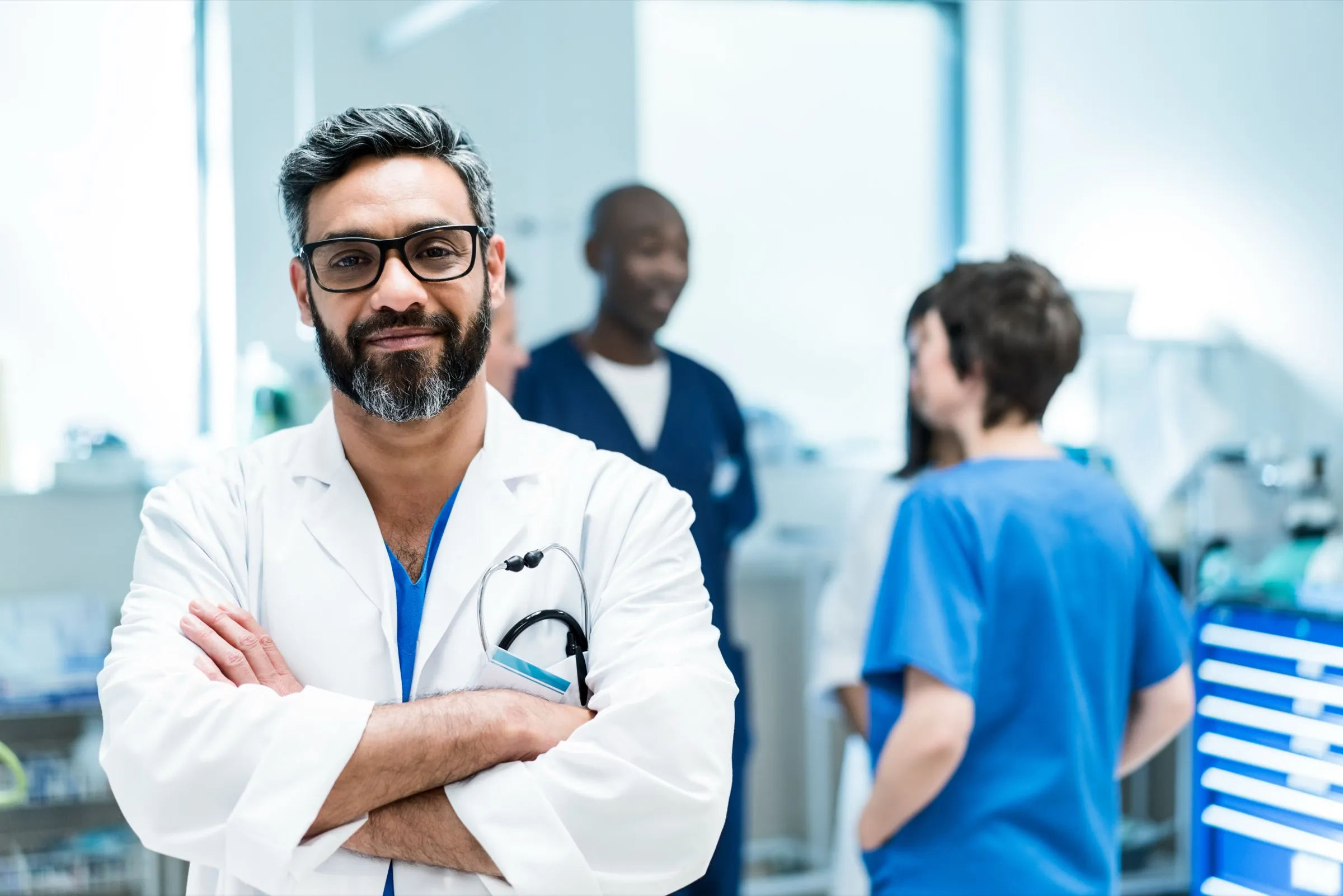 Physician standing with colleagues in a hospital