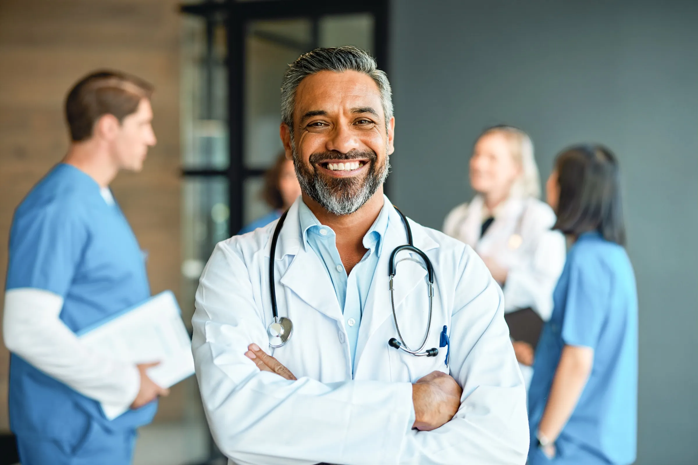 Physician standing with a care team in a hospital