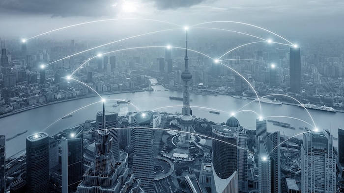 Aerial view of the Shanghai skyline across the Huangpu River, overlaid with a network of connected points