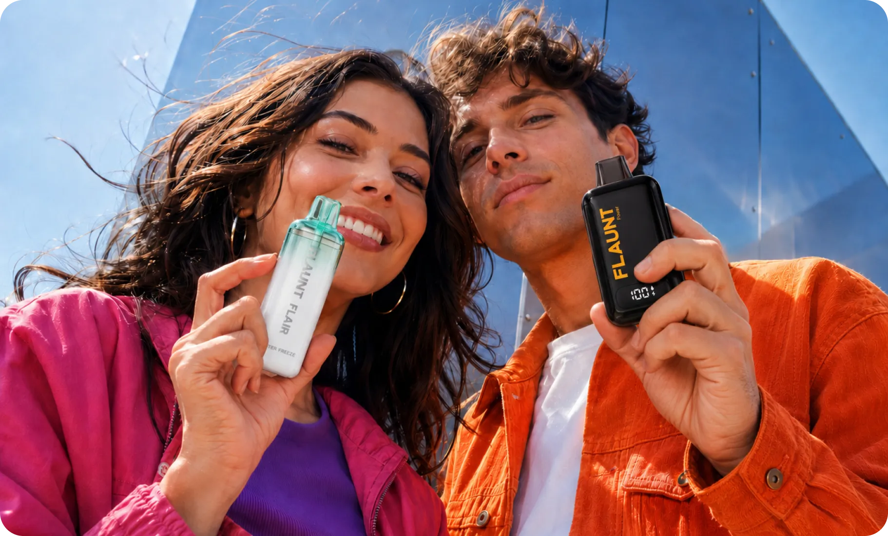 Two friends outdoors holding Flaunt devices on a sunny day