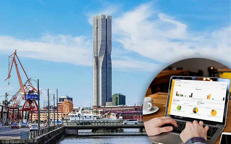 Göteborgs stadssiluett med hamnkranar och höghus, infälld bild av arbete i Planima på en laptop