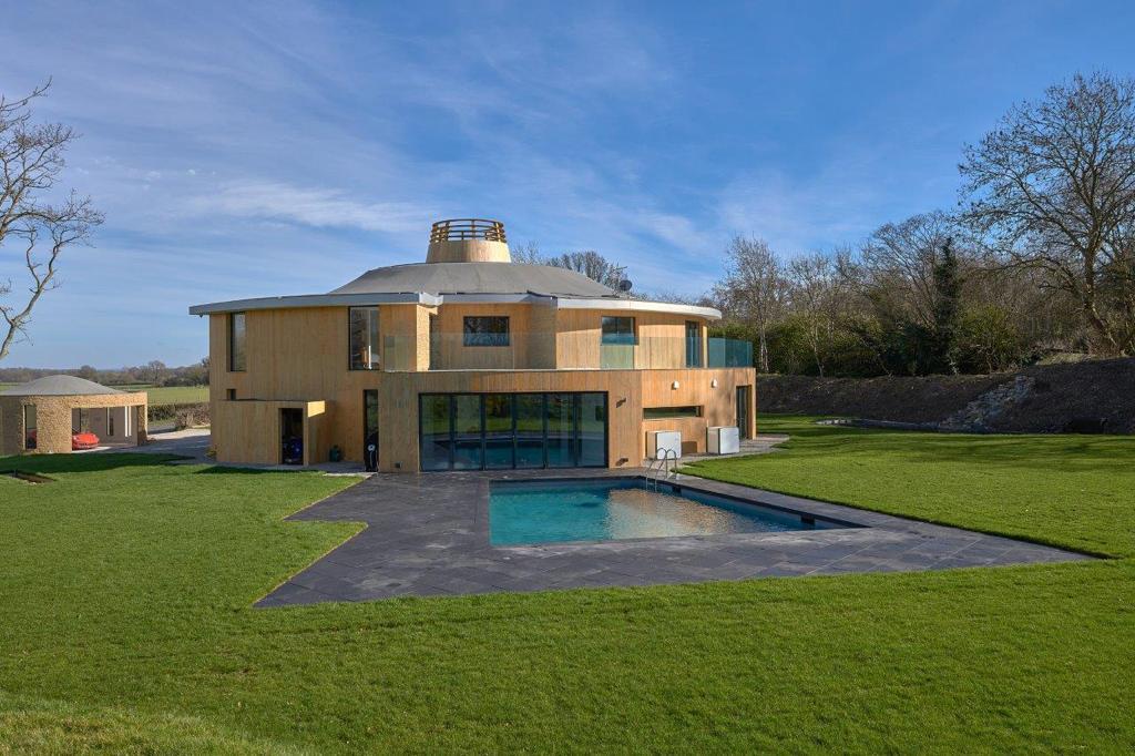 Griffon House — exterior, timber-clad facade with pool and lawn