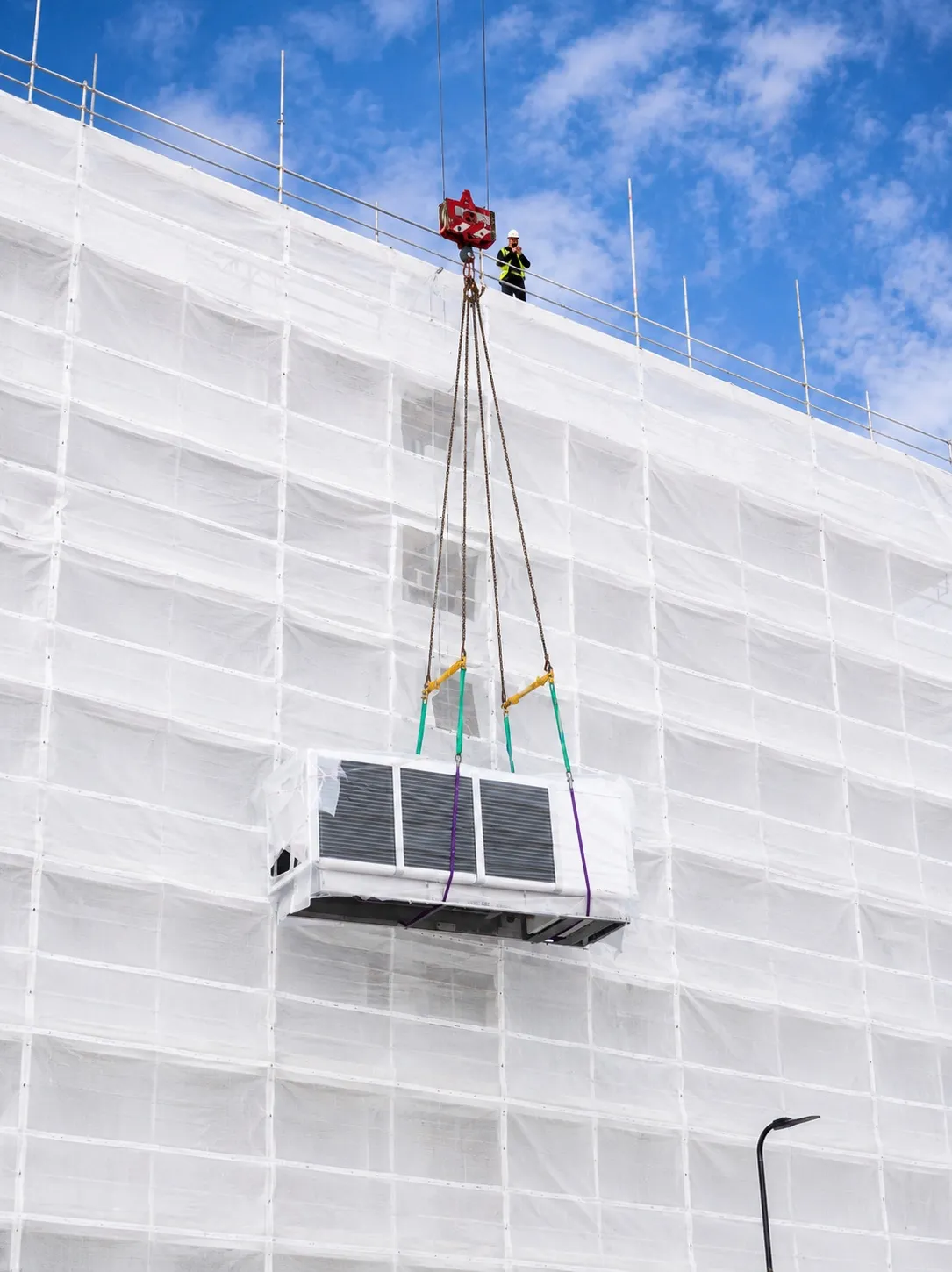 Southall project — rooftop unit lowered on chain rigging