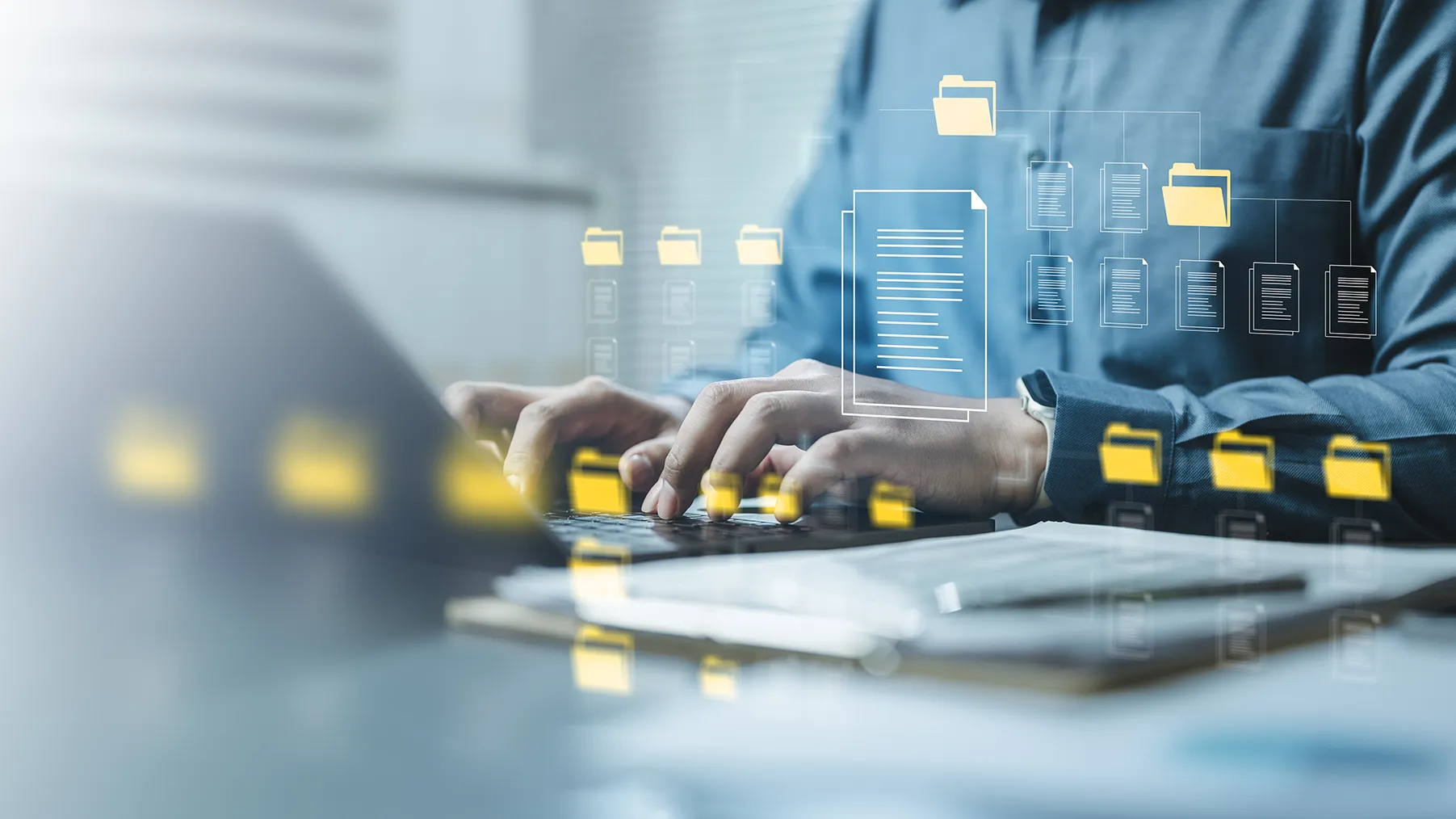 Person typing on laptop with digital folder and document icons representing file management.