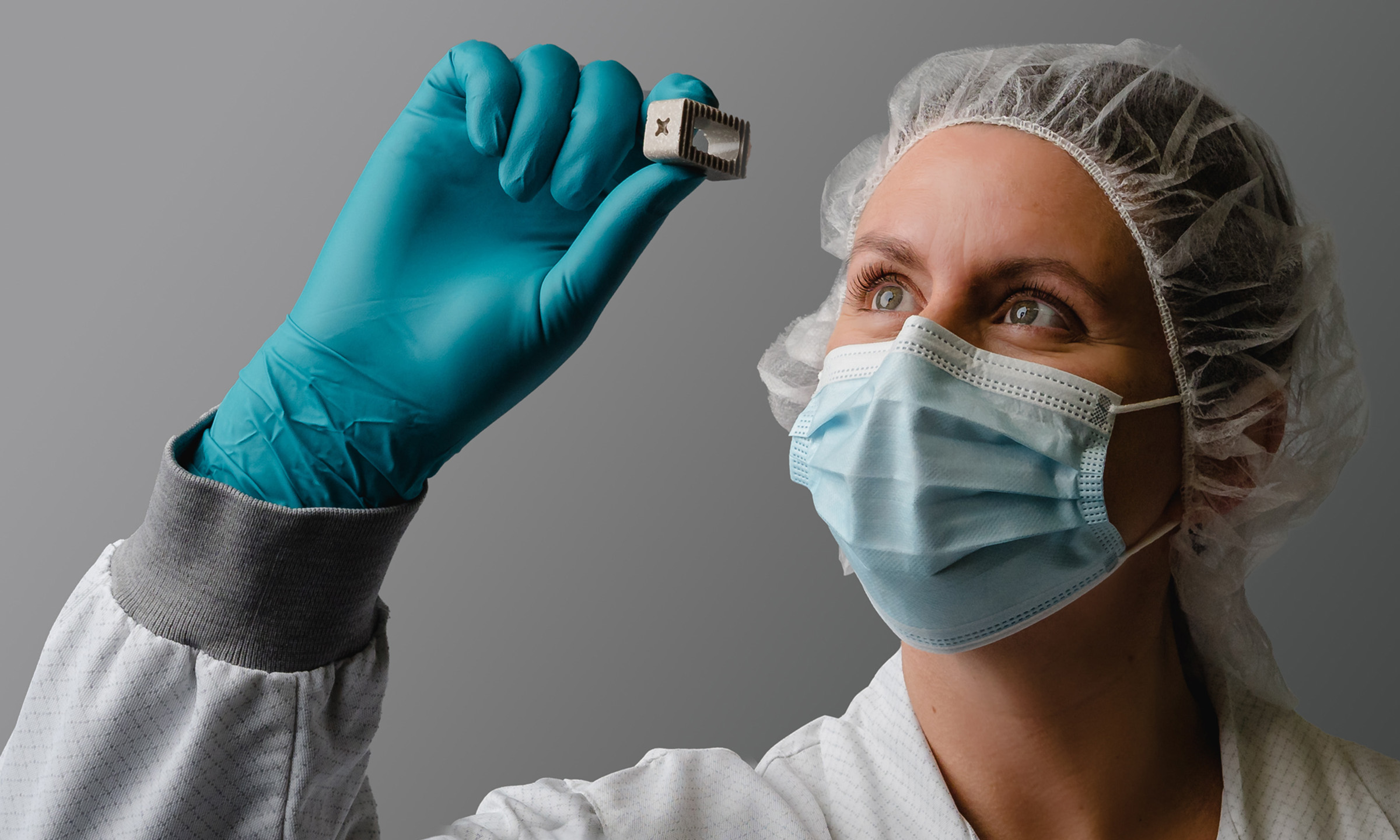 Scientist holding a piece of Skelite up to the light