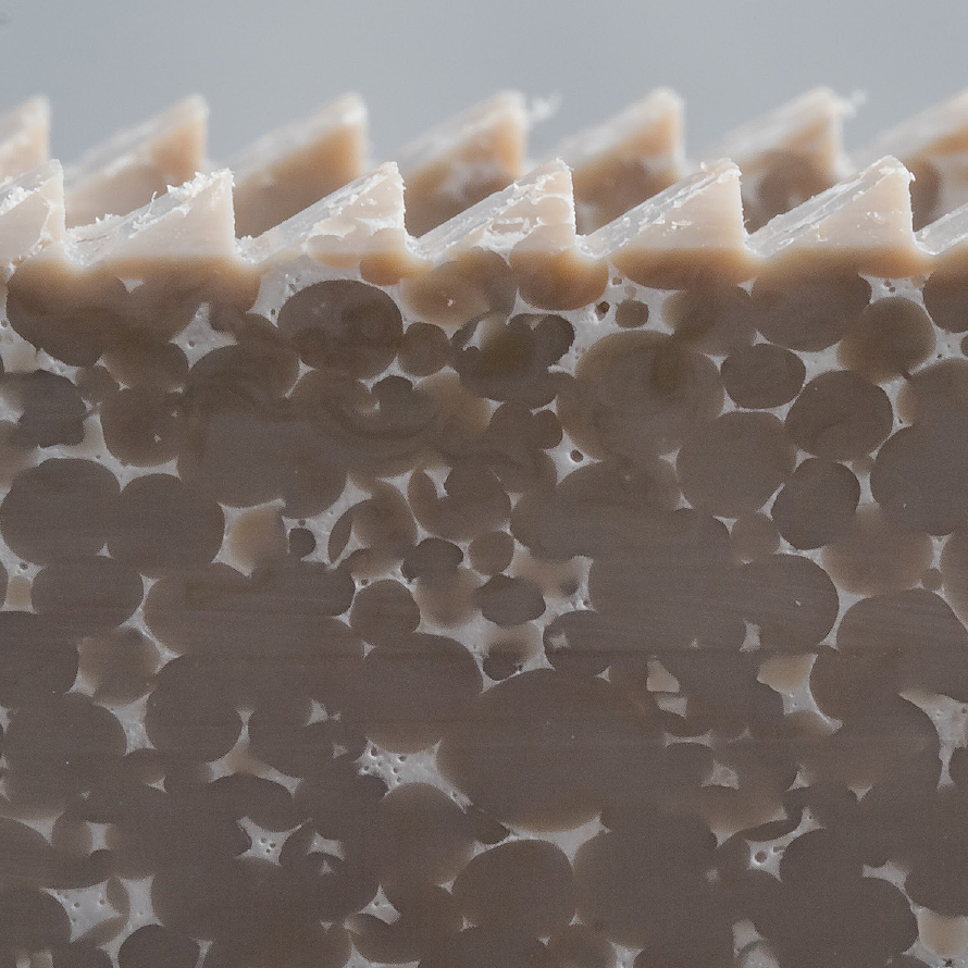 Close-up cross-section of Octane HyperPEEK showing surface teeth and a porous interior.