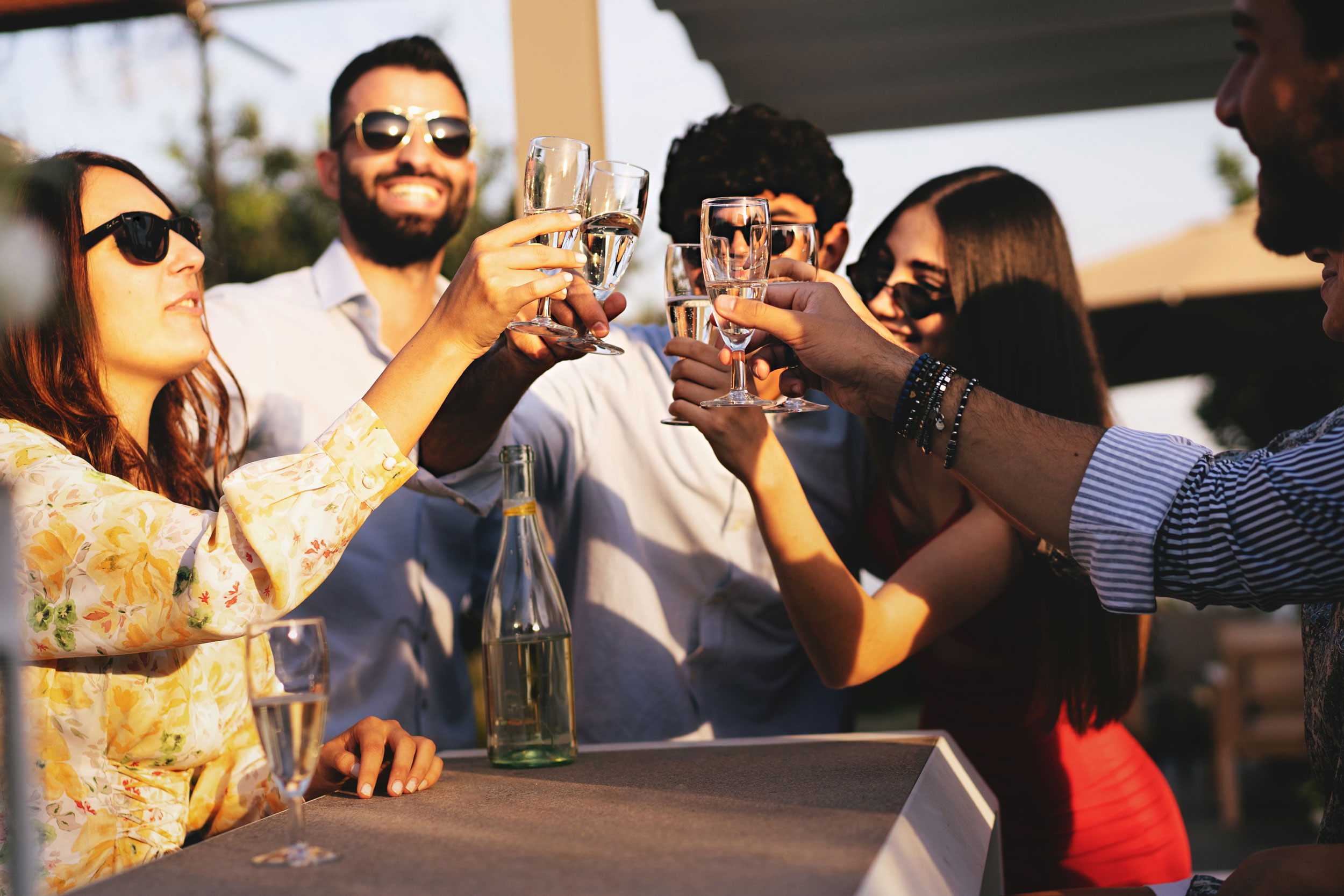 People socializing over drinks on an outdoor terrace