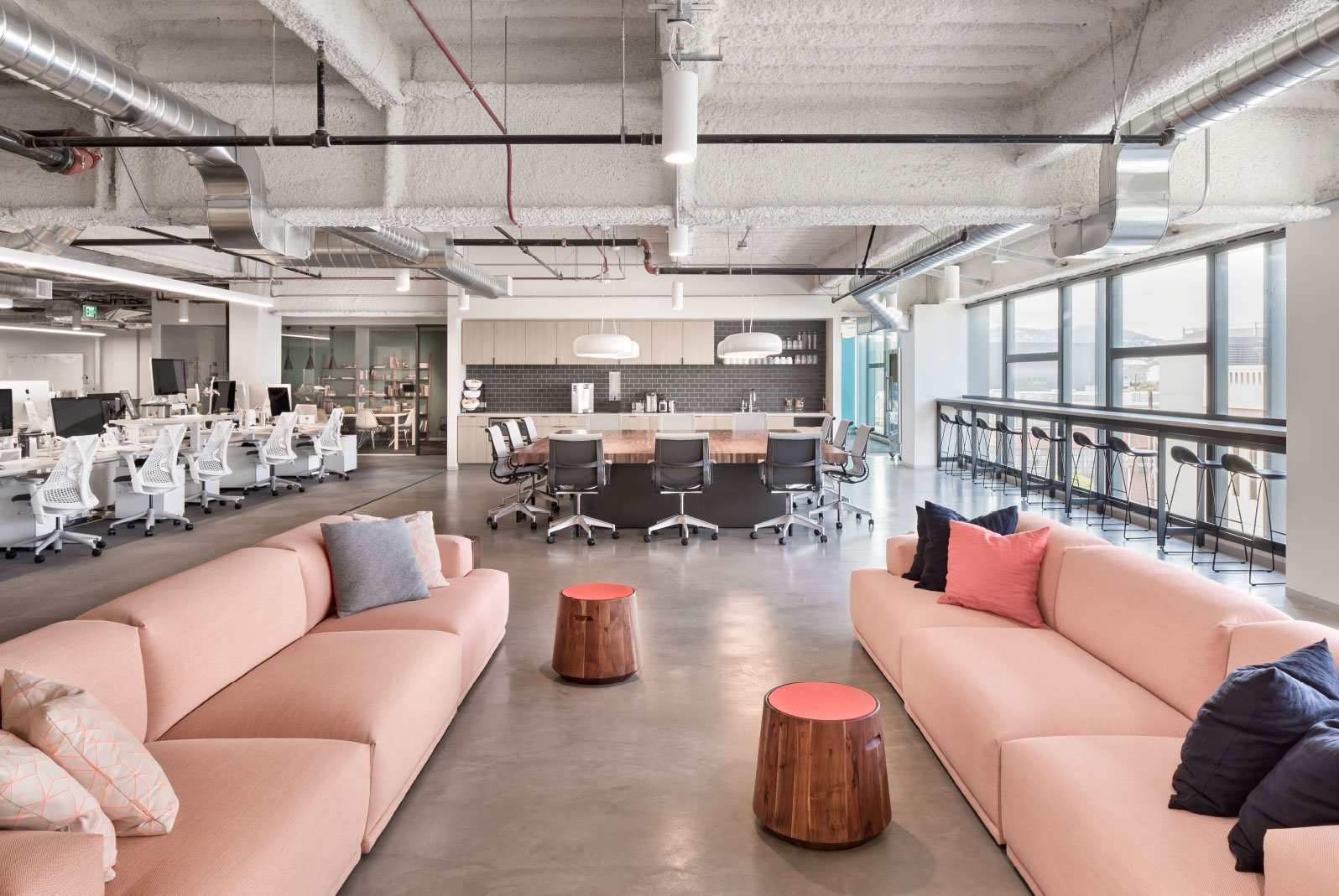 Open office lounge with pink sofas