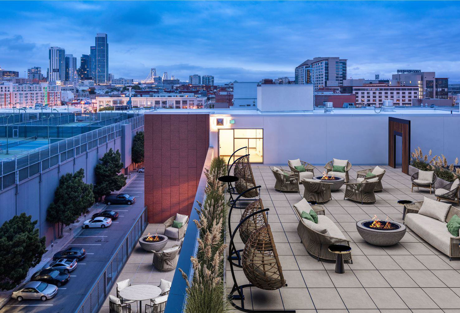 Rooftop terrace with seating, fire pits, and city views