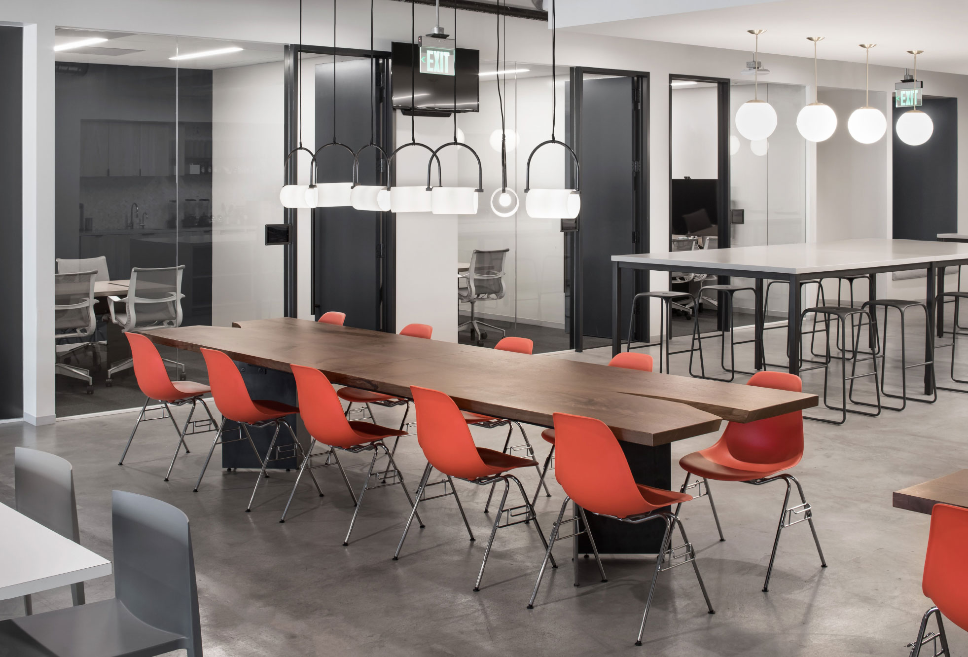 Communal dining area with red chairs