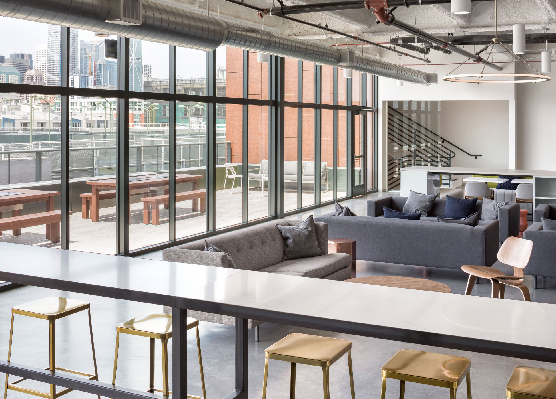Indoor lounge beside a terrace with city views